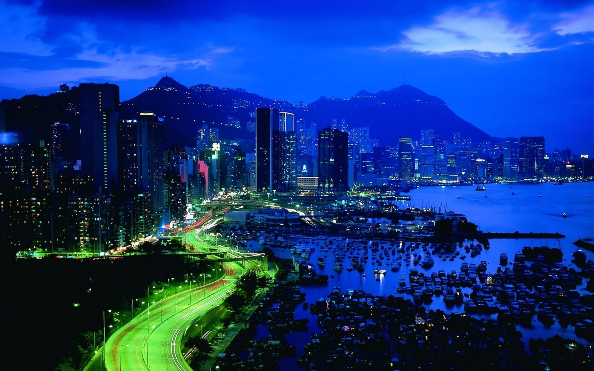 Hong Kong cityscape at night with Victoria Harbour and mountains HD Wallpaper