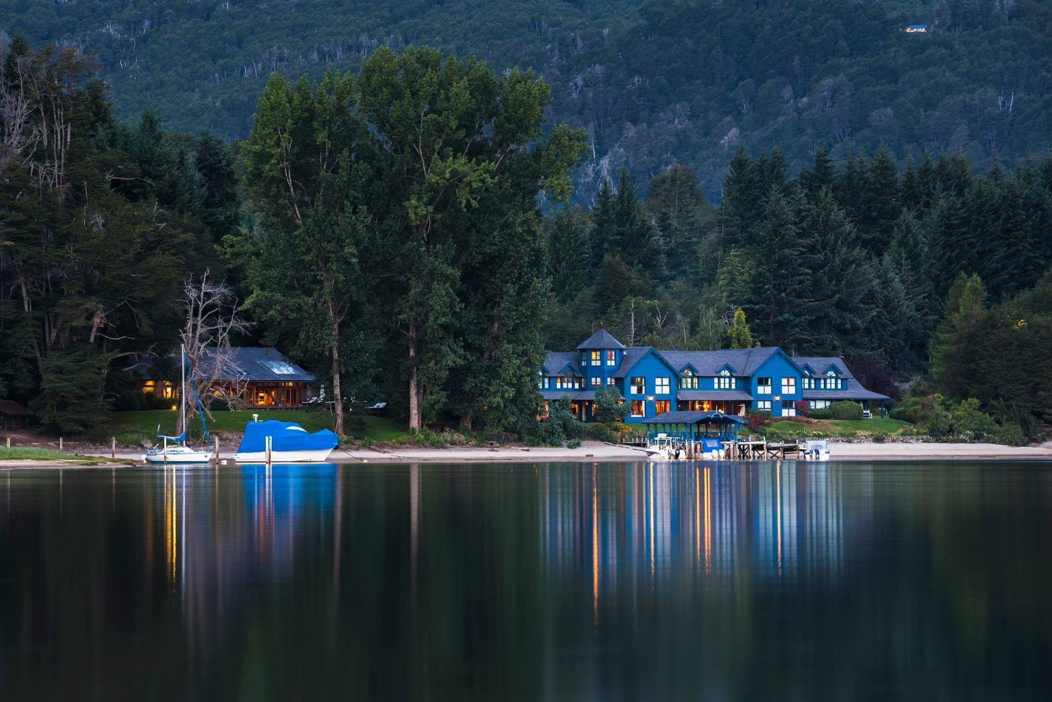 Blue house on a lake with forest and mountains HD Wallpaper