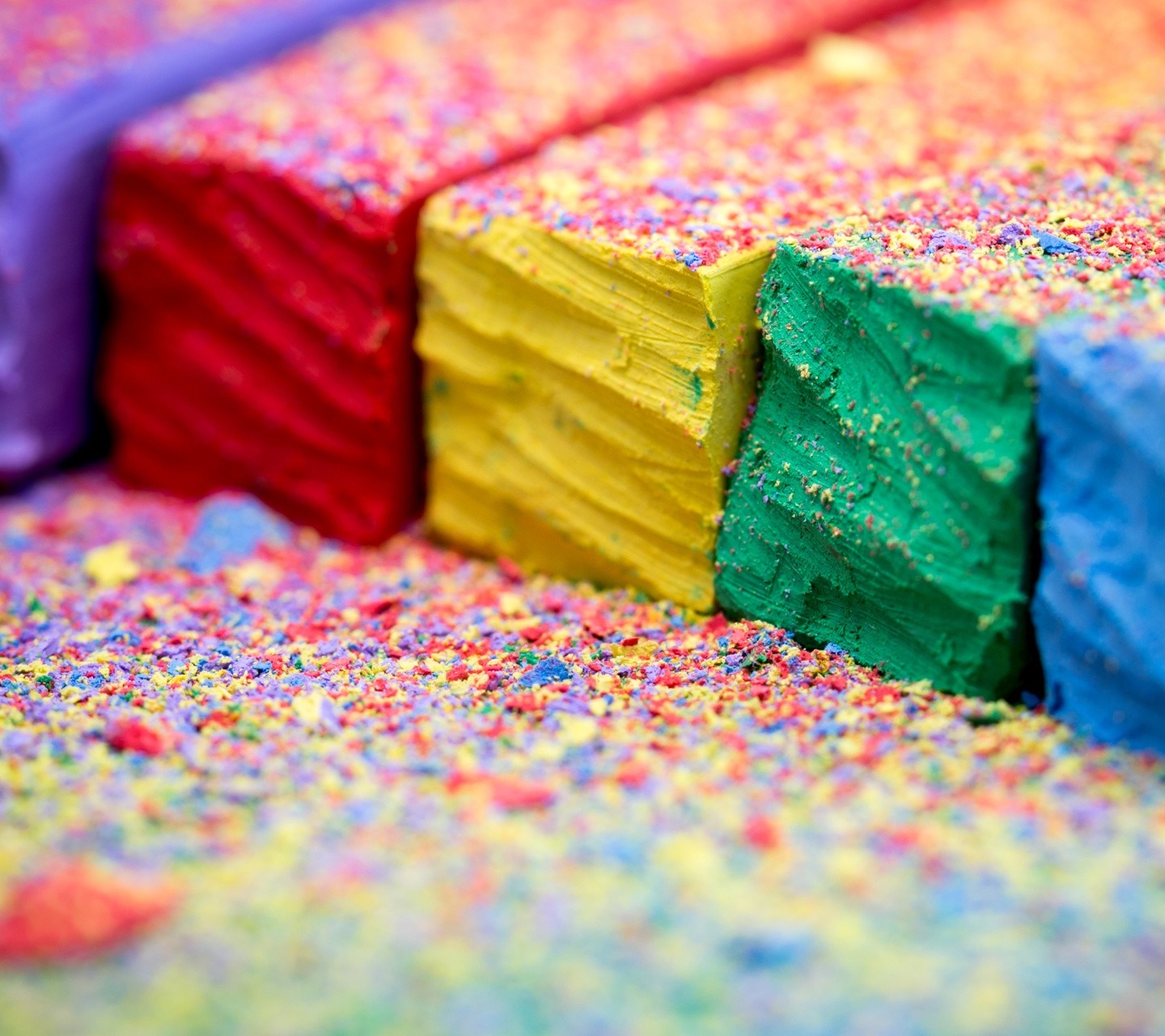 Colorful chalk pieces with scattered powder HD Wallpaper