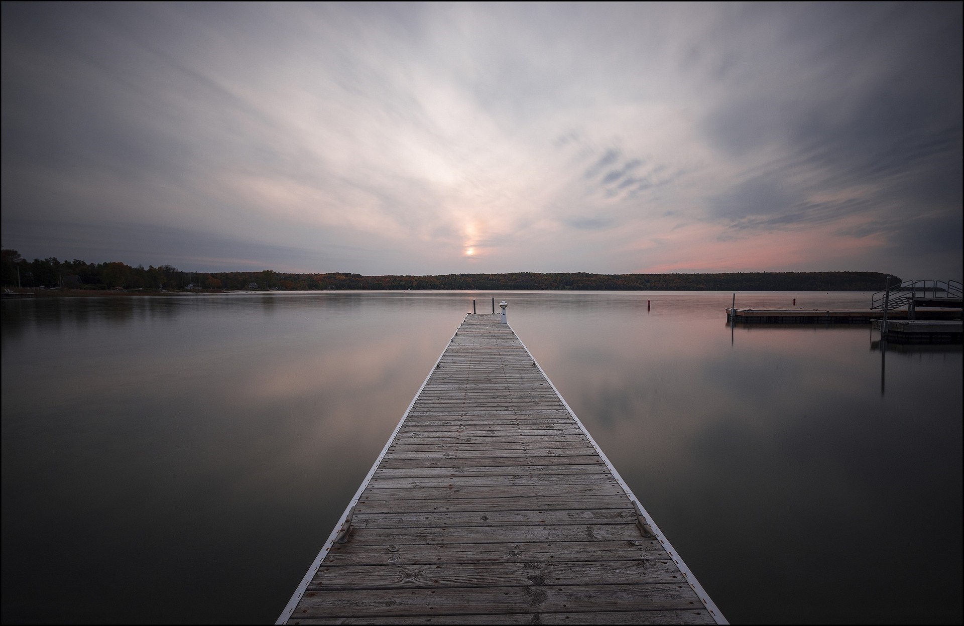 Wooden dock on a calm lake at sunset HD Wallpaper