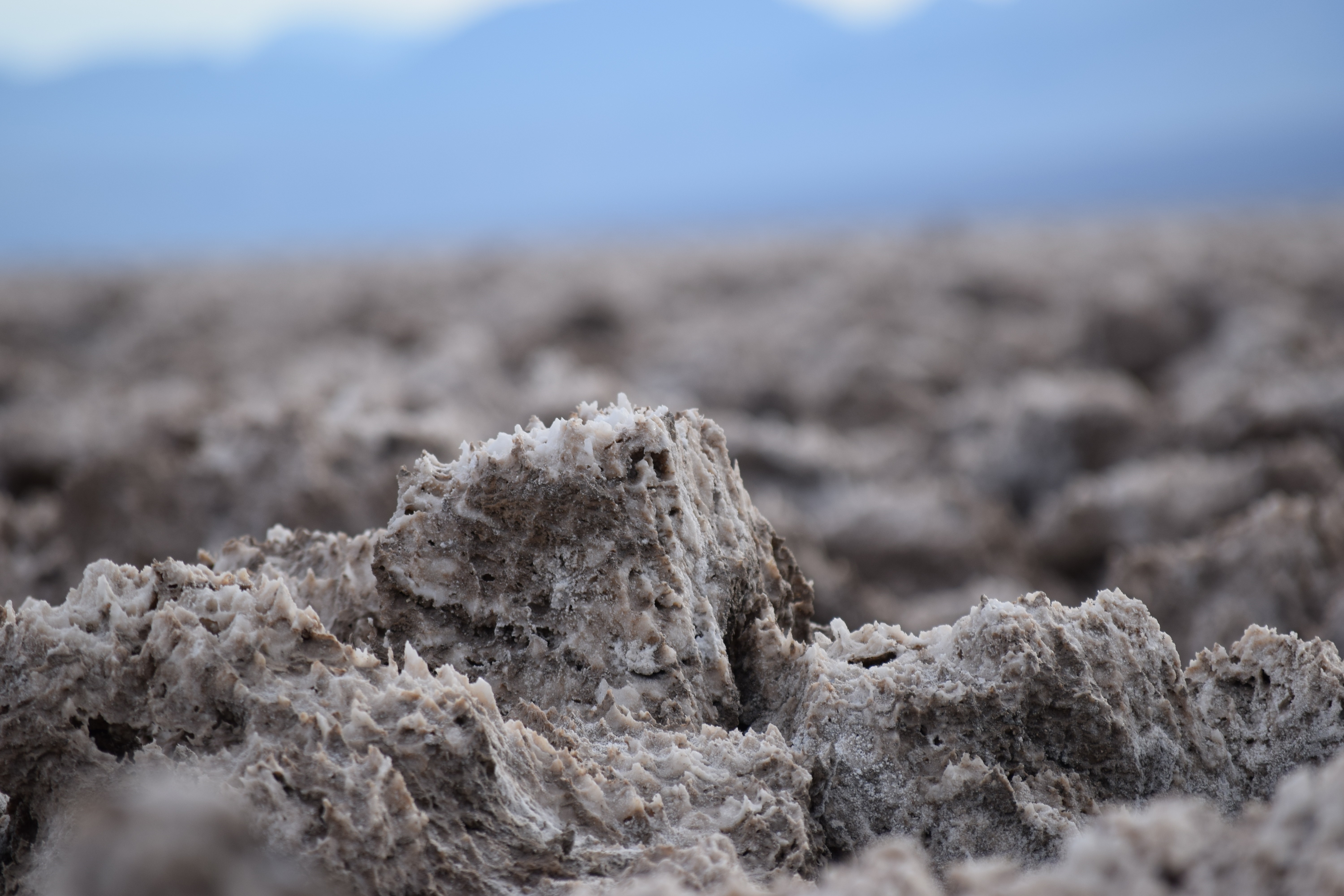 Salt flats with mountains in the background HD Wallpaper