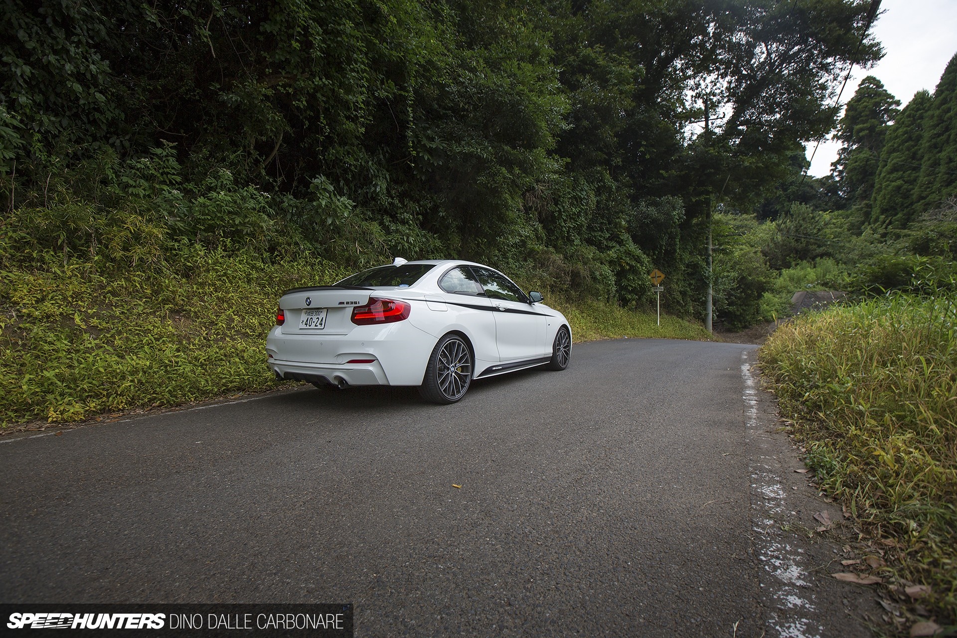 White BMW M235i on a winding road HD Wallpaper