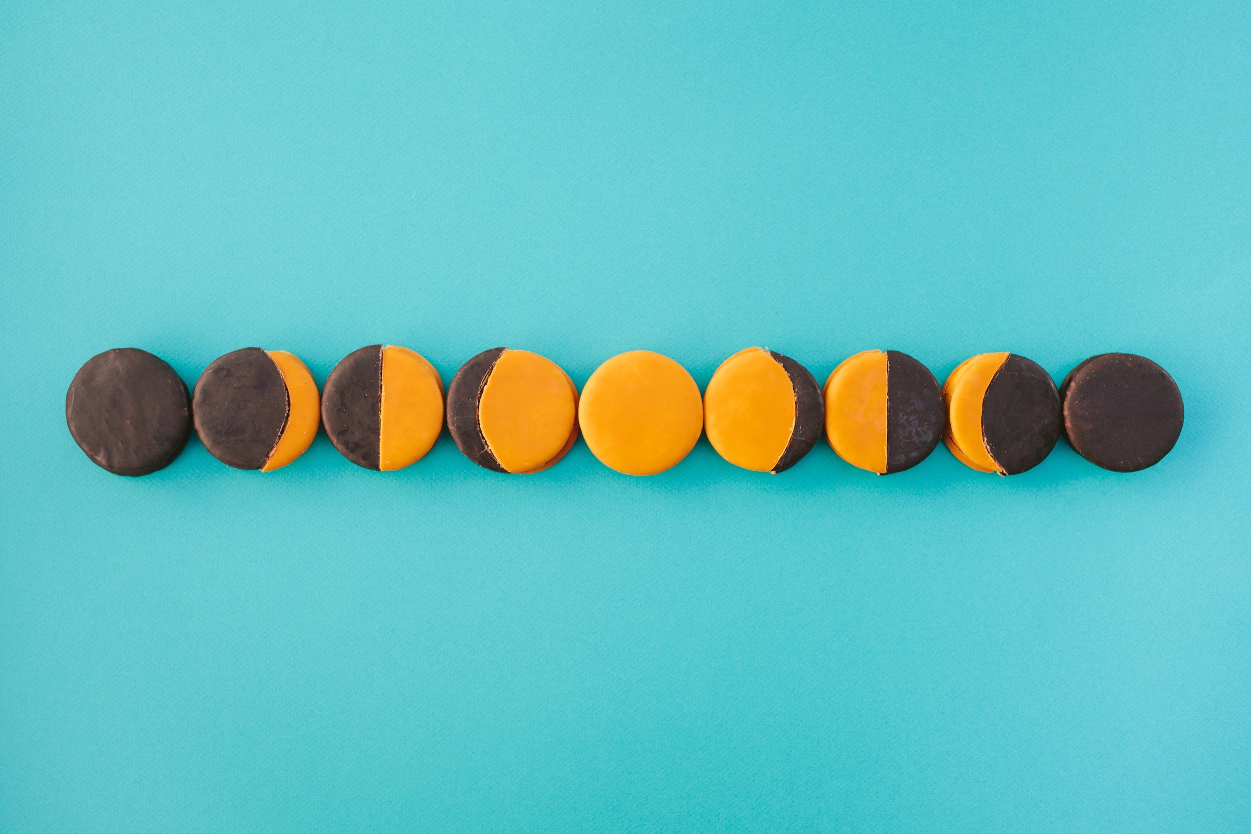 Moon phase cookies on blue background HD Wallpaper