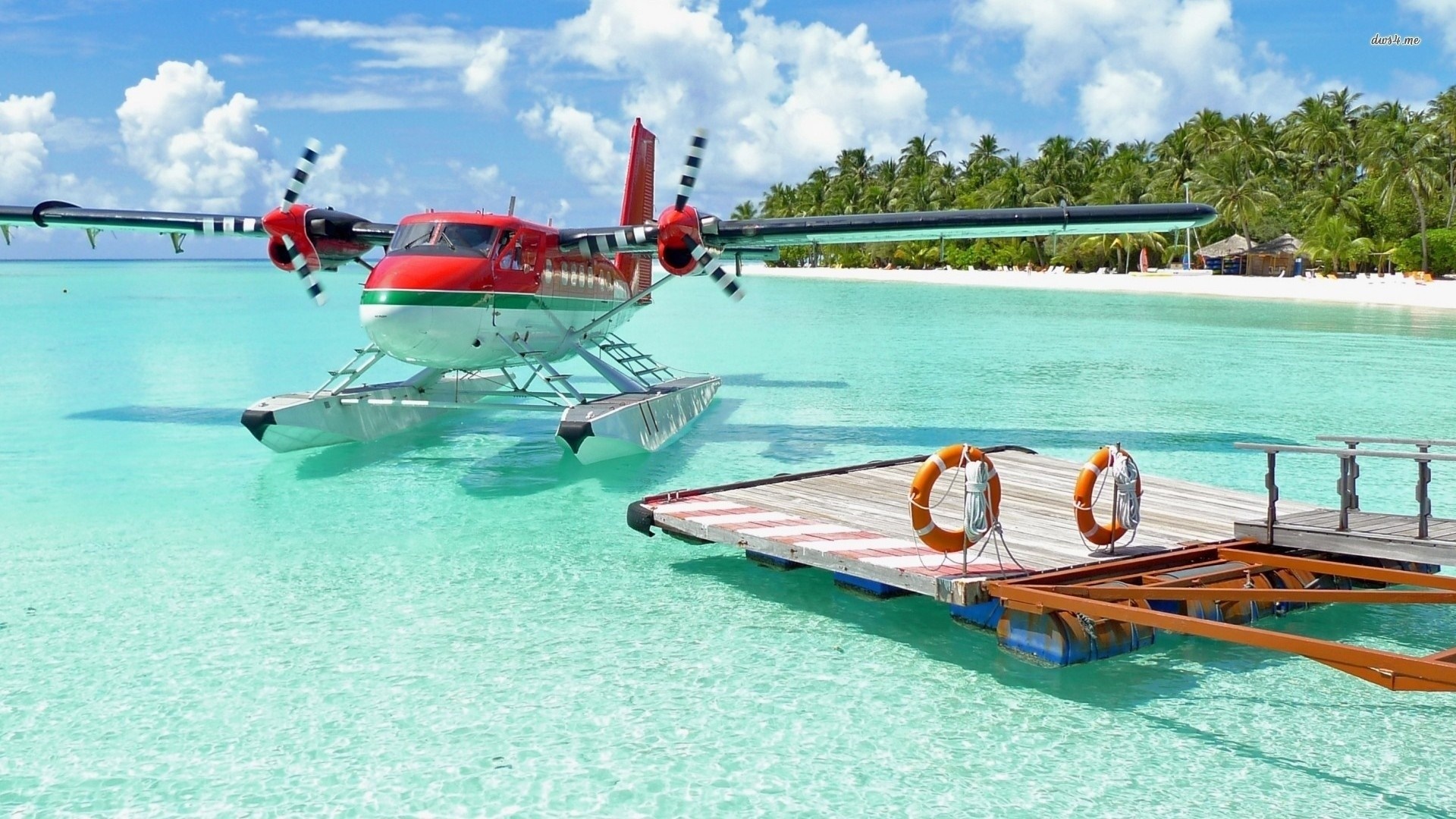 Seaplane docked at a tropical island pier HD Wallpaper