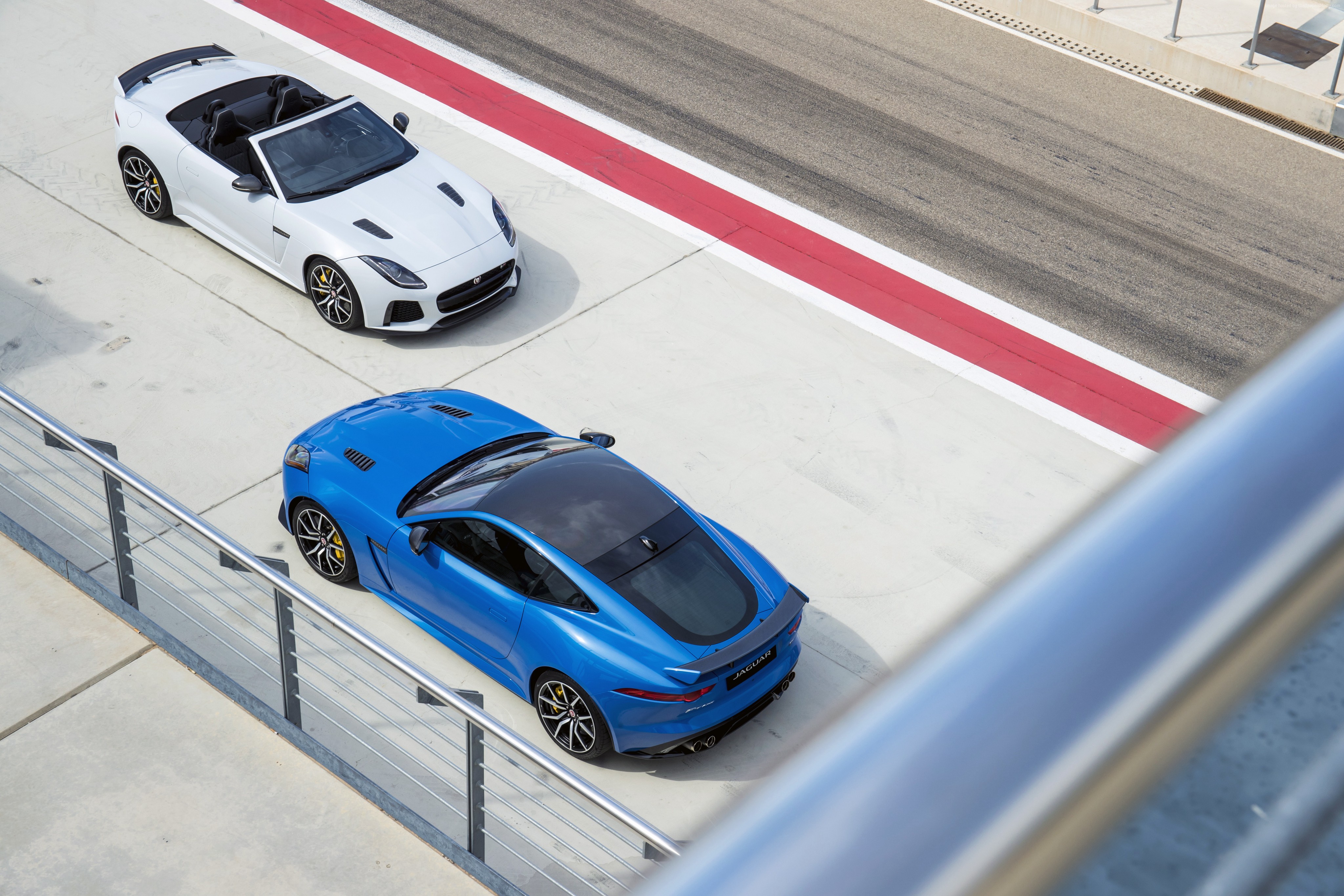 Two Jaguar F-Type SVR sports cars on a racetrack HD Wallpaper