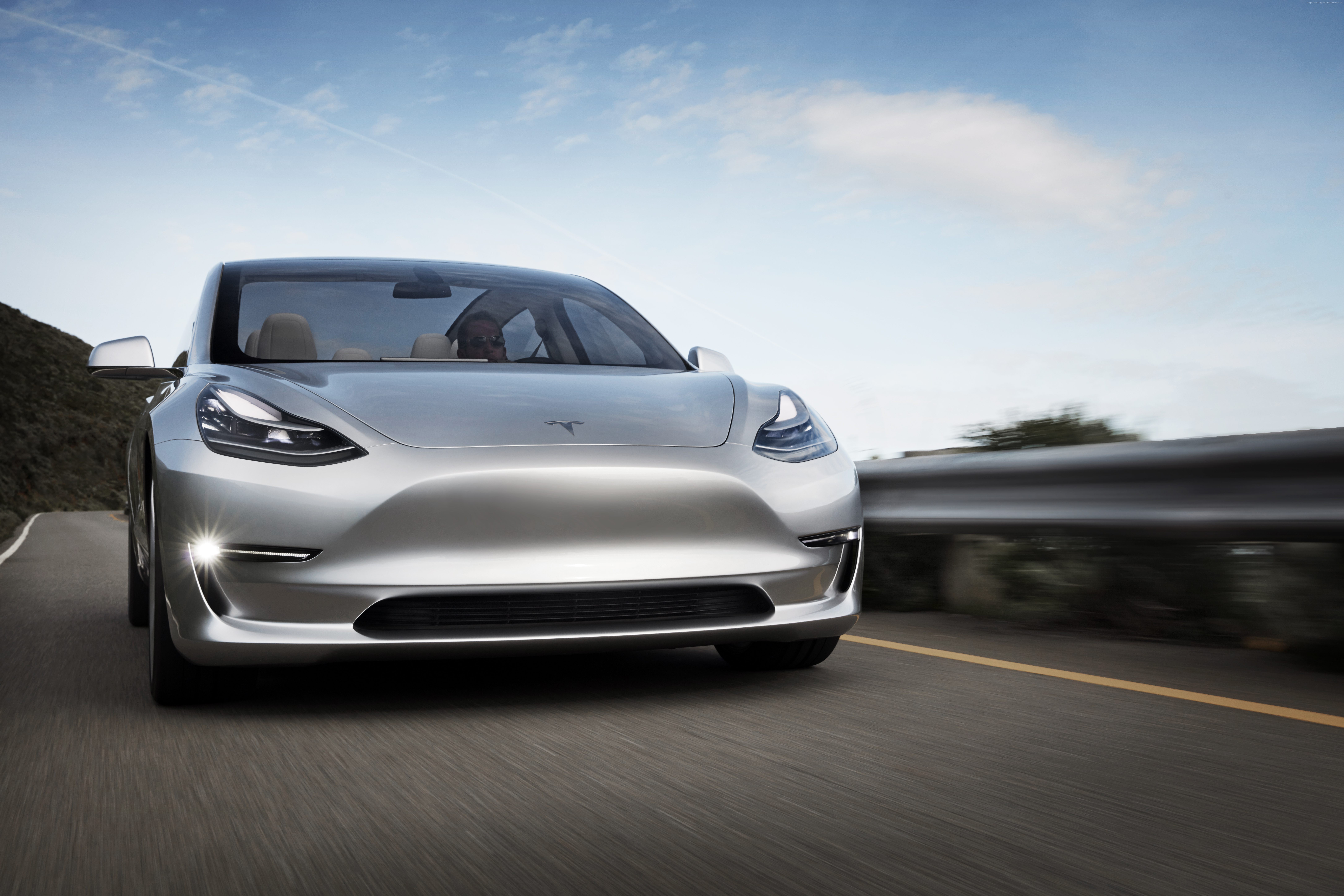 Silver Tesla Model 3 Prototype driving on a road HD Wallpaper