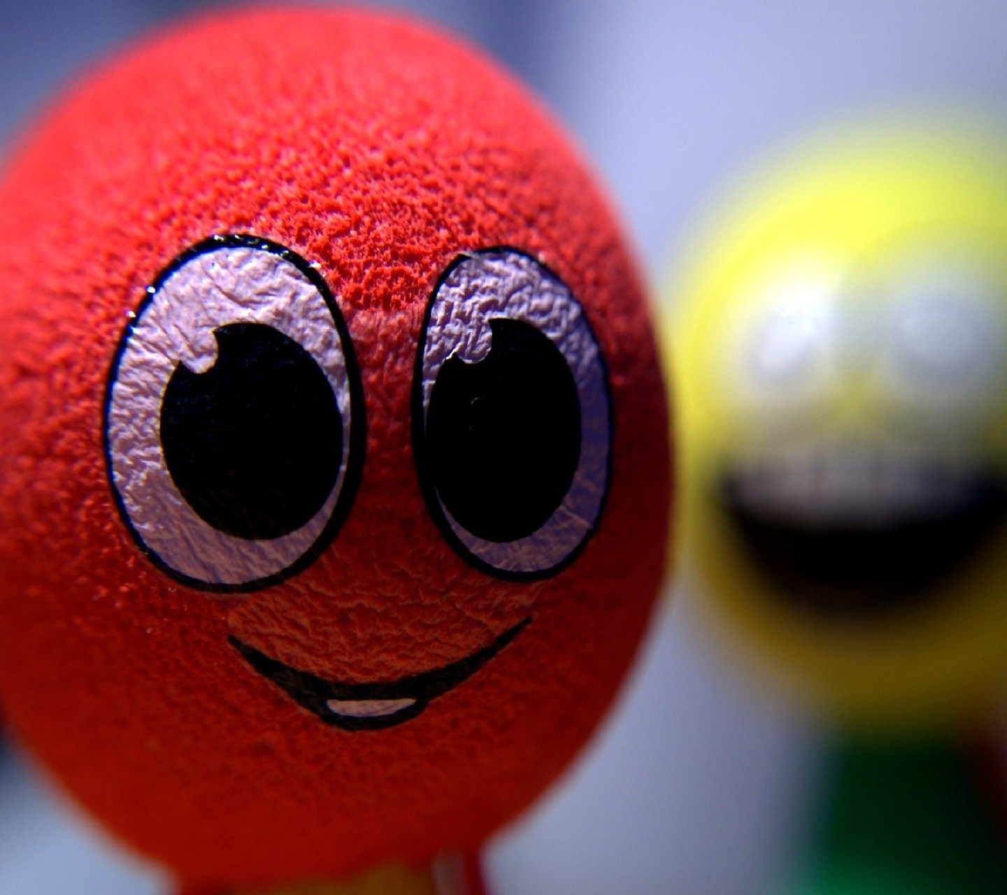 Close up of a red toy with big eyes and a smile HD Wallpaper