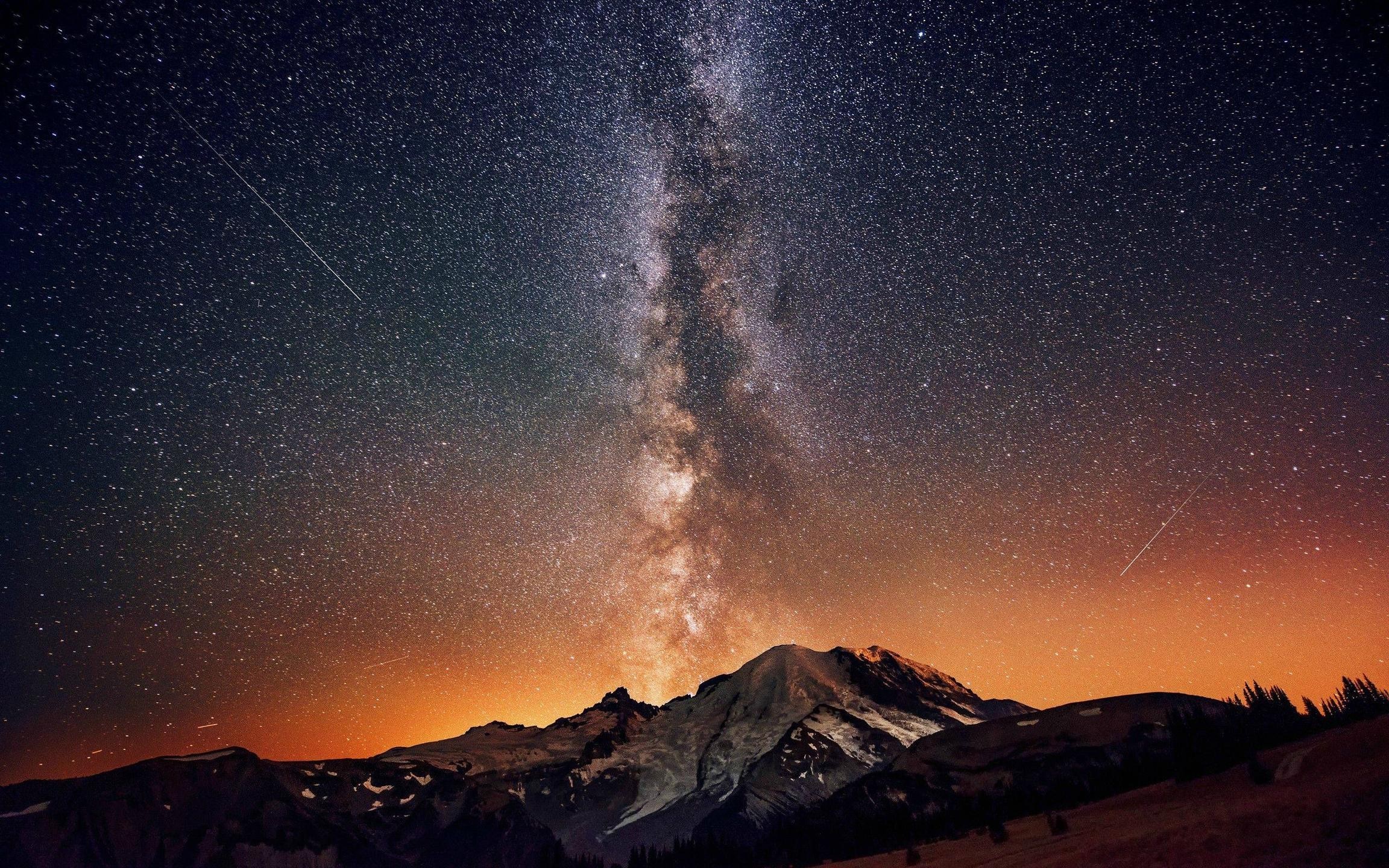 Milky Way galaxy over snow-capped mountains at night HD Wallpaper