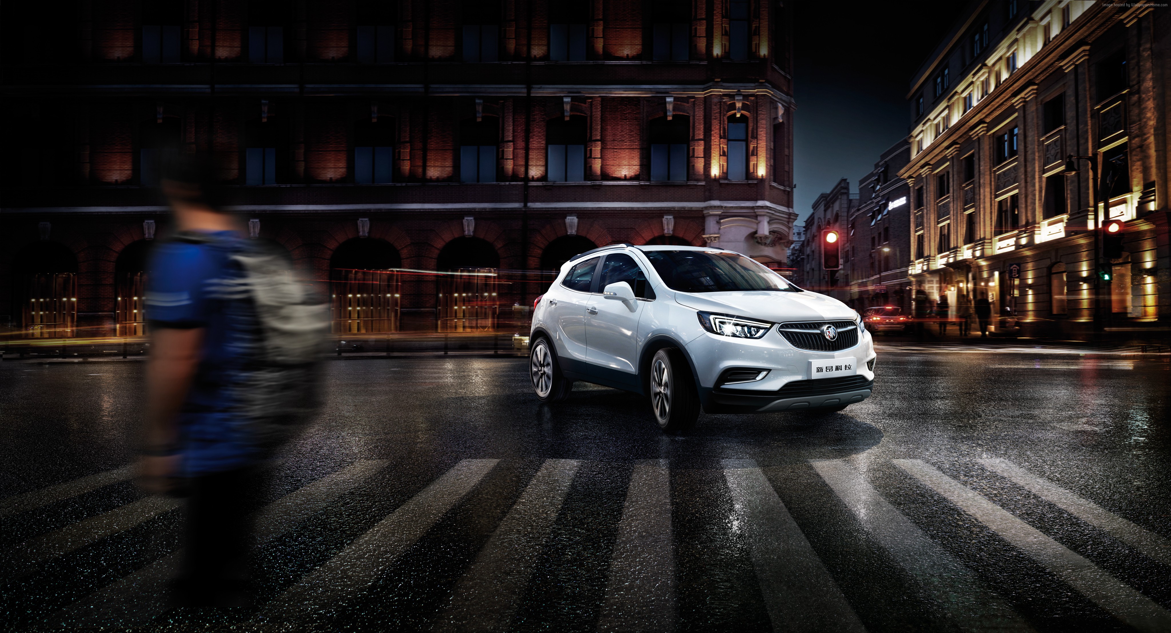 White Buick Encore crossover on a wet city street at night HD Wallpaper