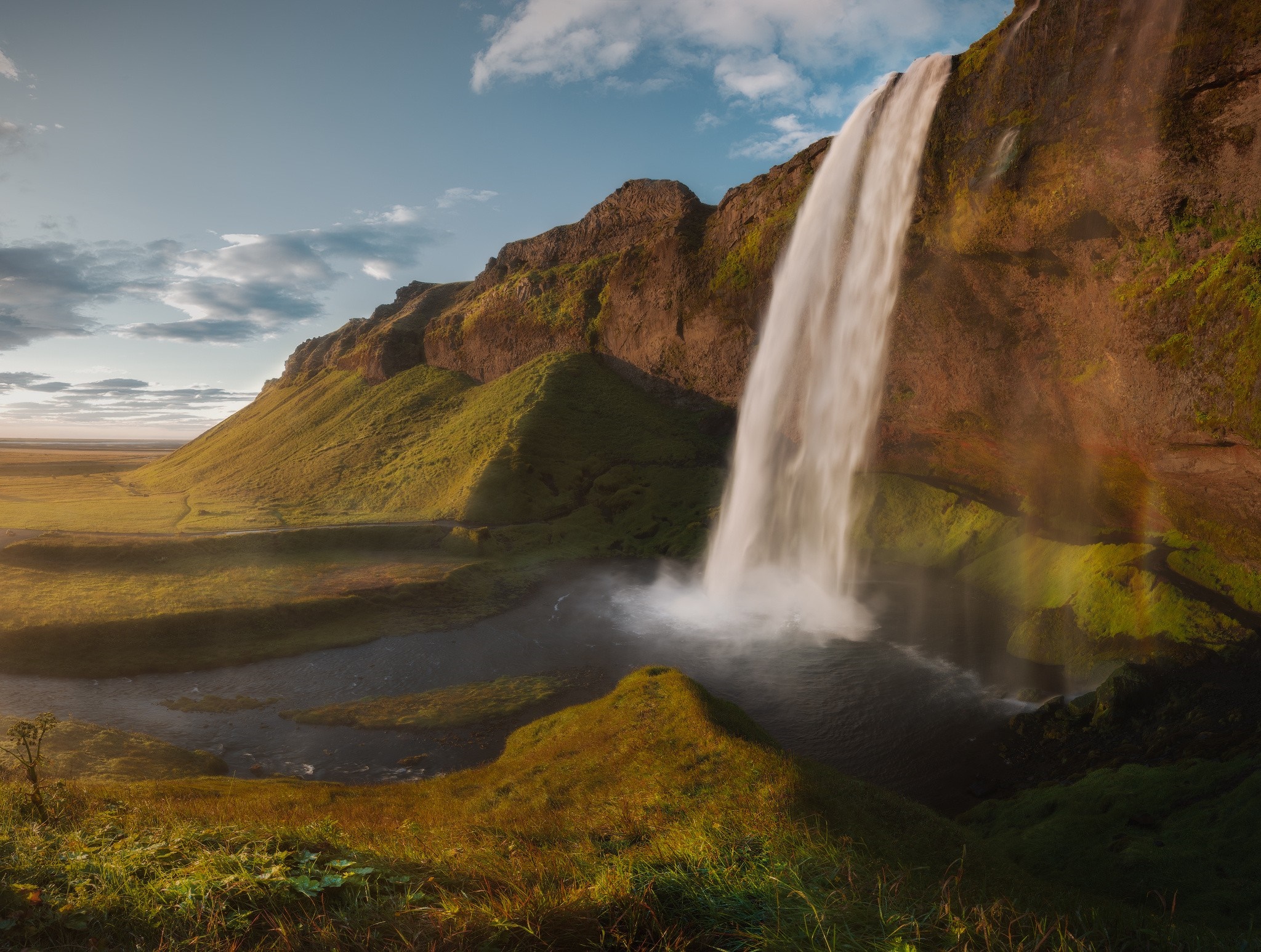 Seljalandsfoss waterfall in Iceland with green hills HD Wallpaper