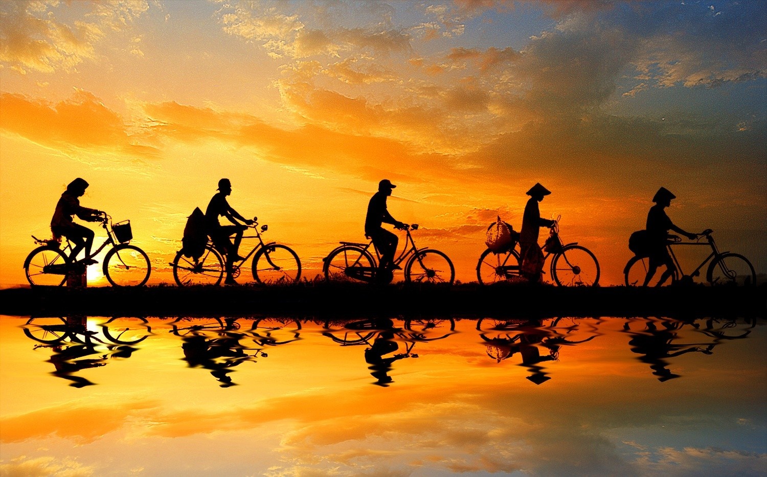 Silhouettes of people riding bicycles at sunset with reflection HD Wallpaper