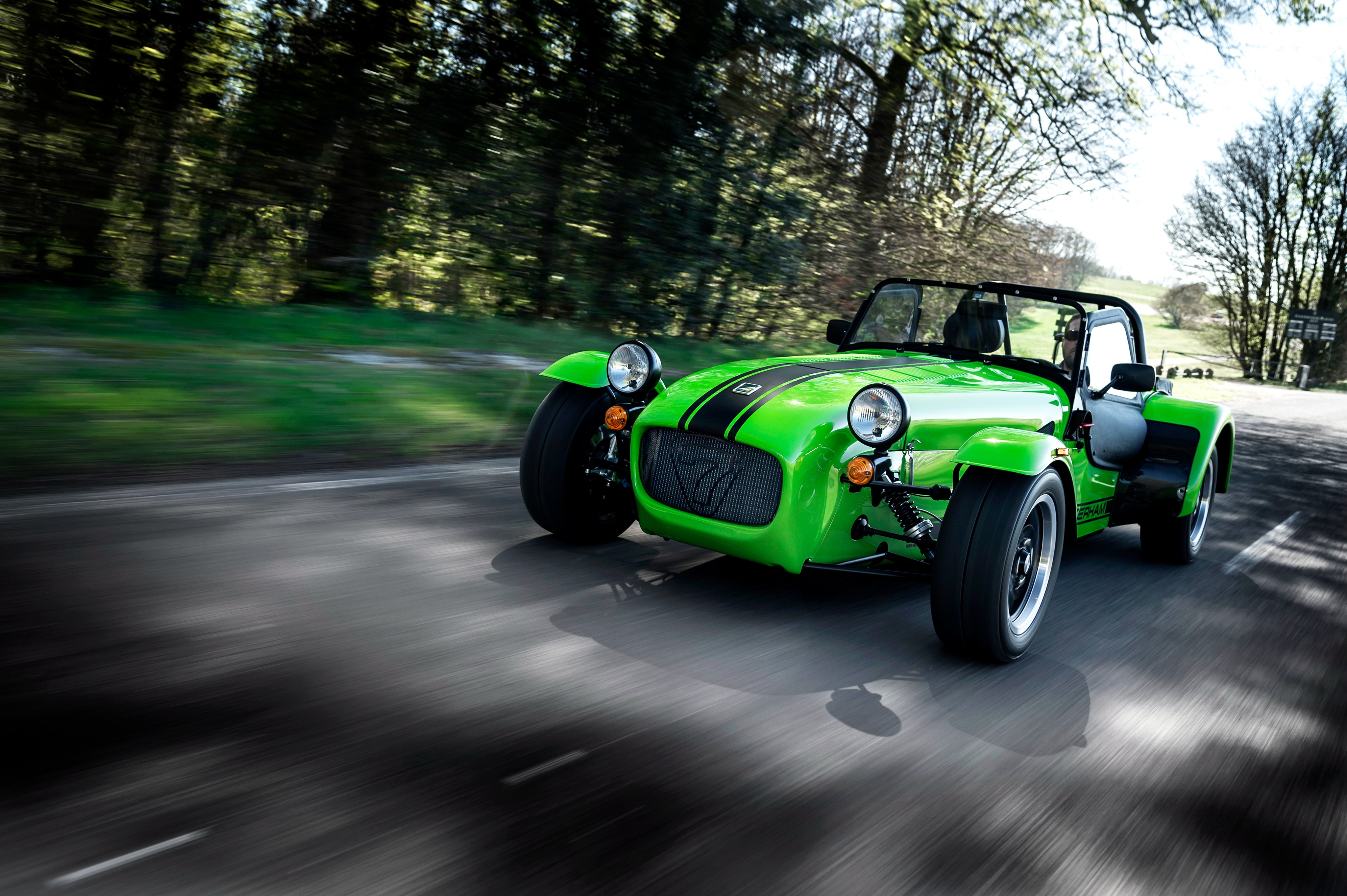 Green Caterham Seven 275 R driving on a road HD Wallpaper