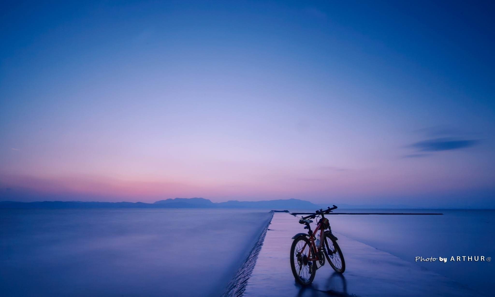 Bicycle on a pier at sunset over the ocean HD Wallpaper
