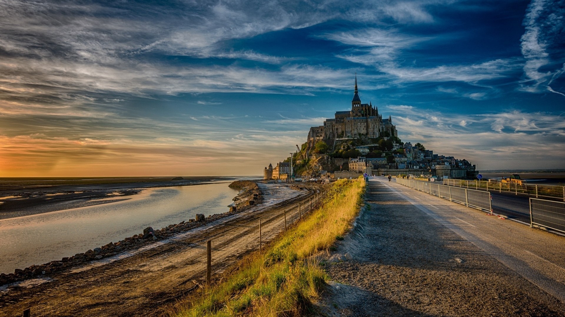 Mont Saint Michel at sunset with a road and water HD Wallpaper