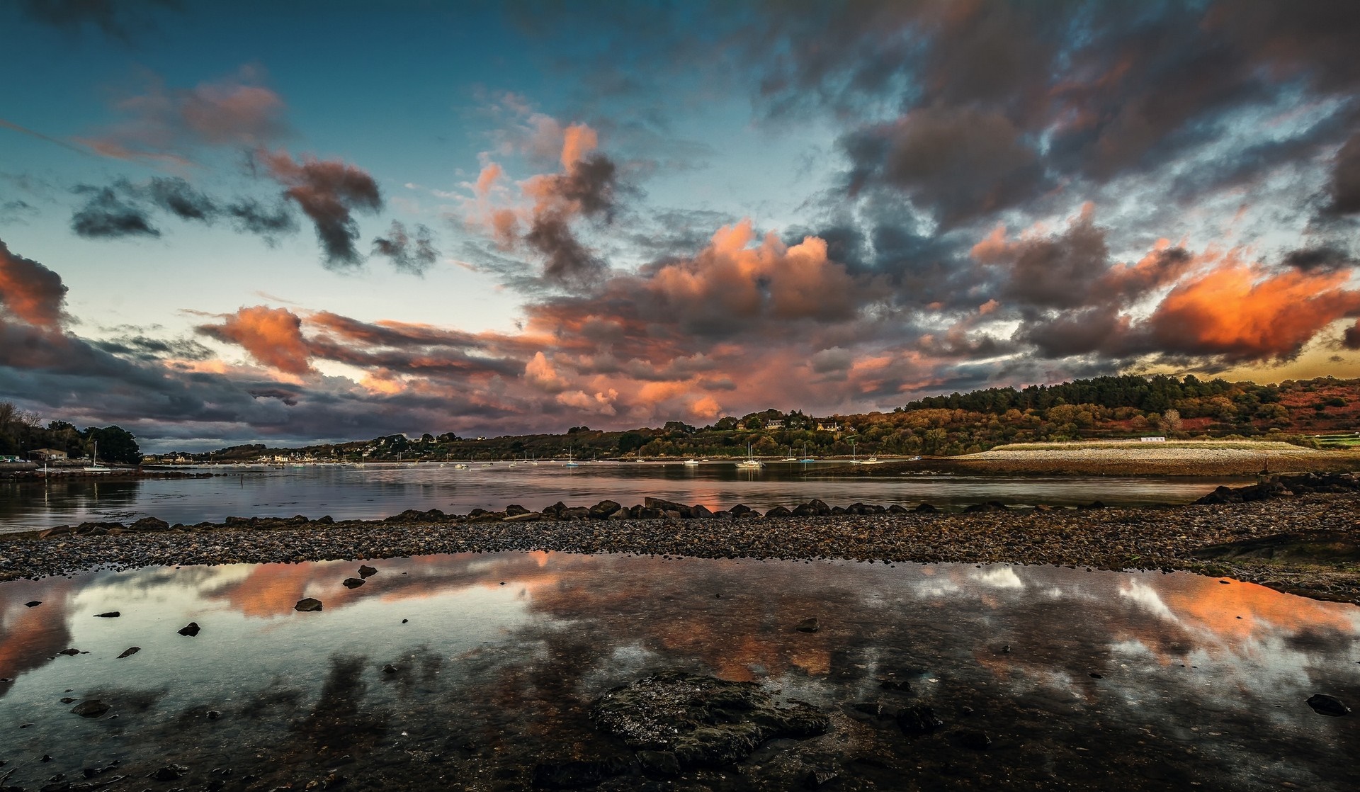 Sunset over a calm sea with colorful clouds and reflections HD Wallpaper