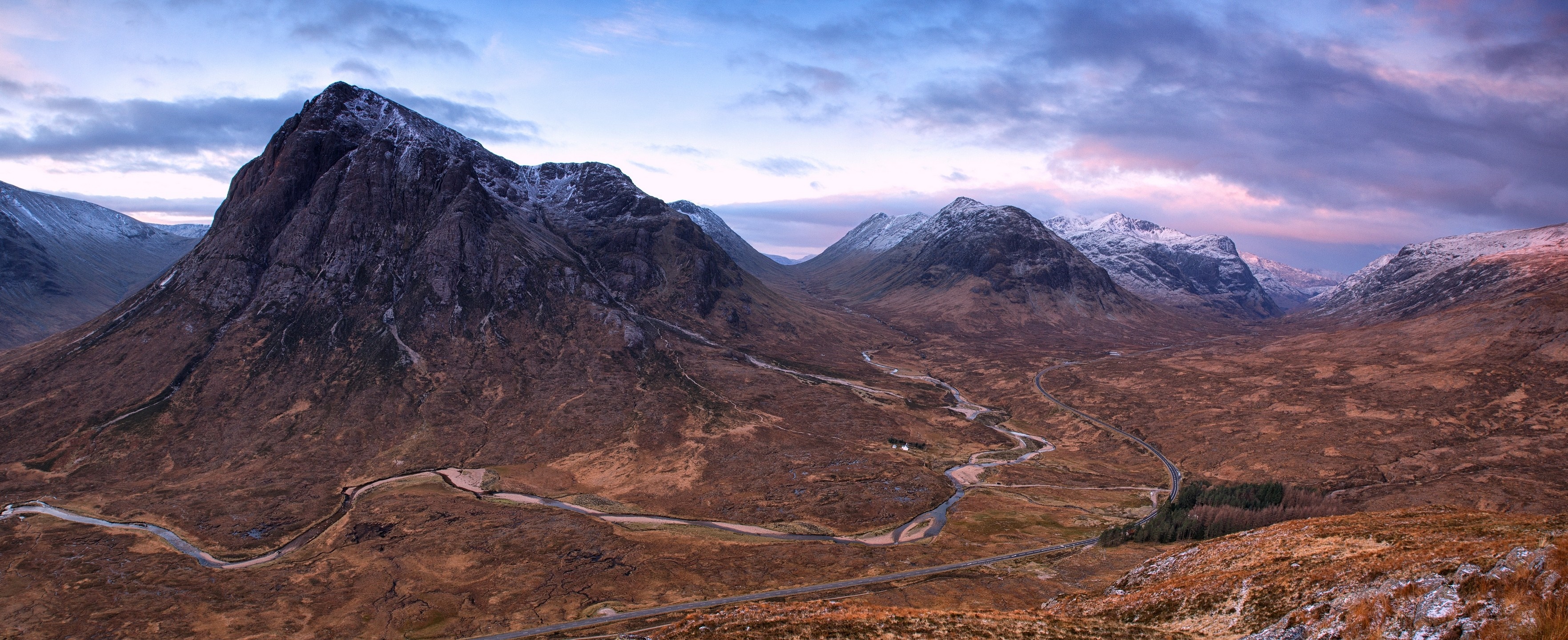 Panoramic view of a mountain valley with snow-capped peaks HD Wallpaper