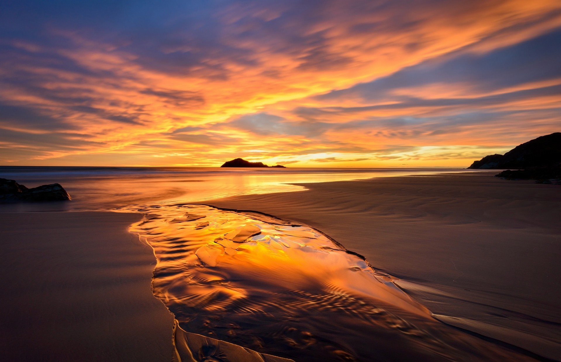 Sunset over a beach with a stream reflecting the sky HD Wallpaper