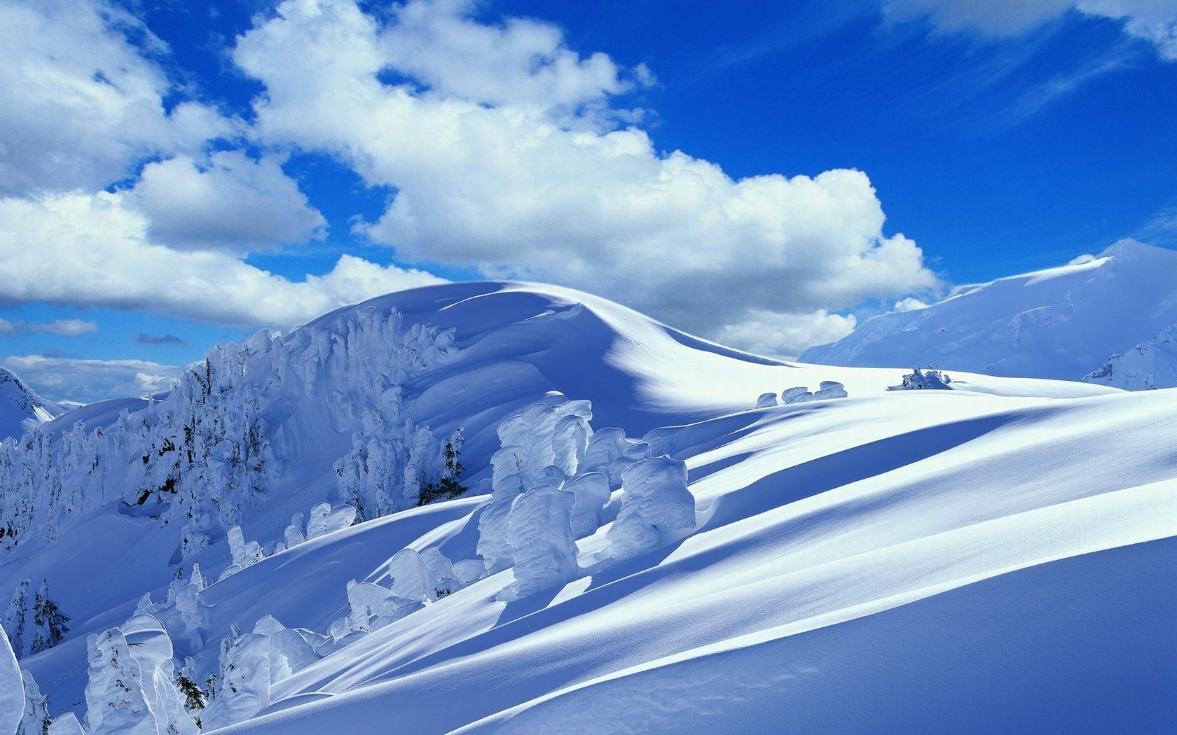 Snowy mountains under a blue sky with clouds HD Wallpaper
