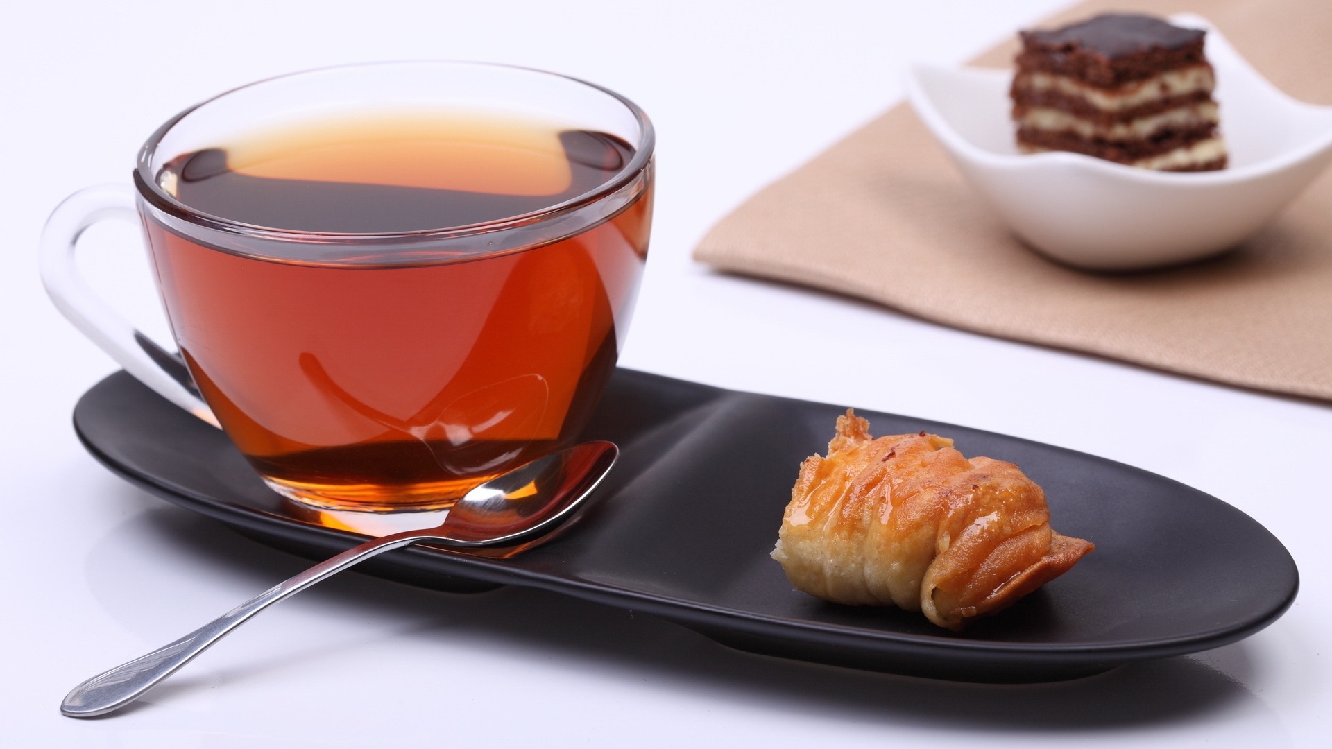 Tea with pastries on a black plate HD Wallpaper