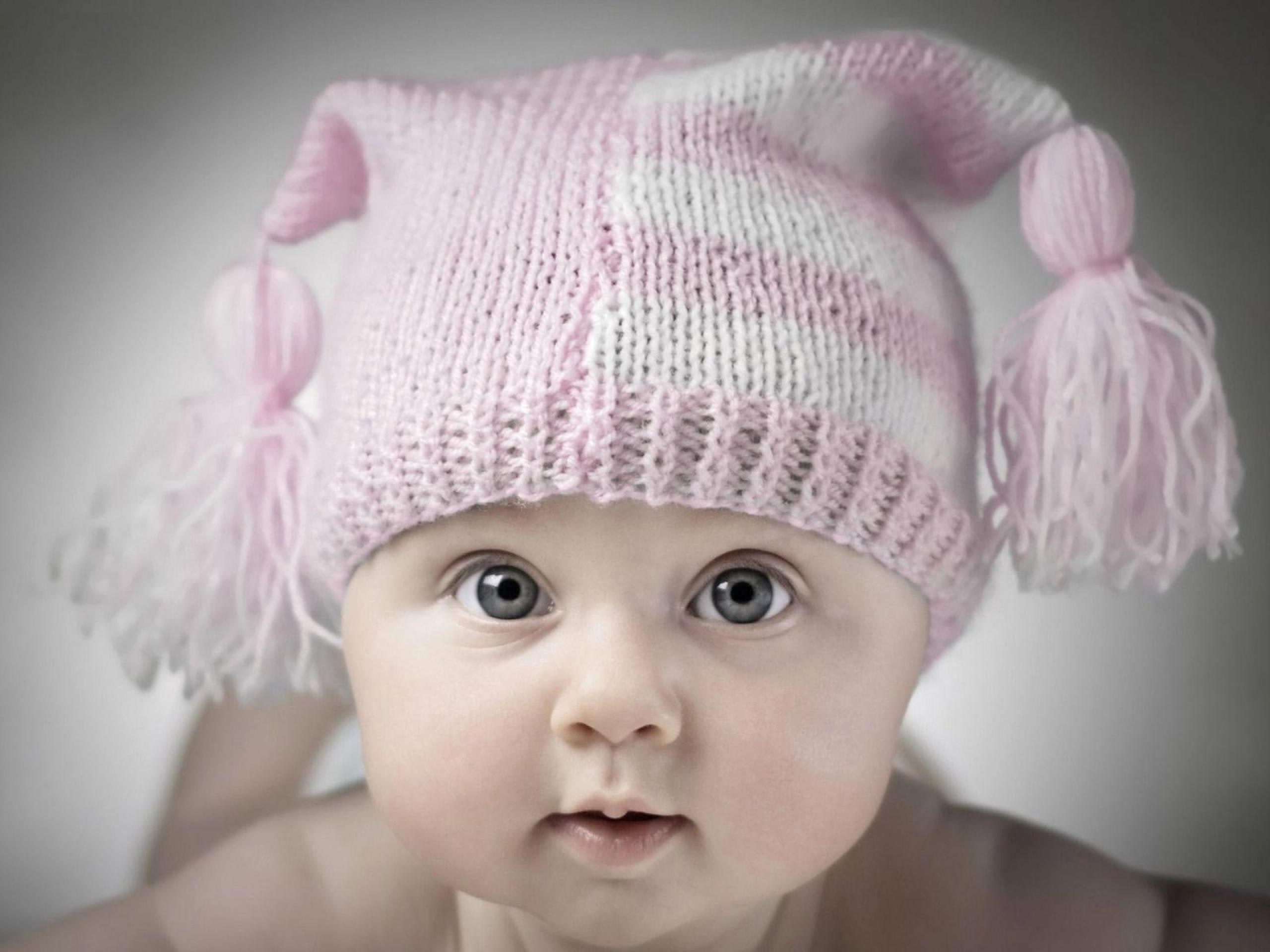 Baby wearing a pink and white striped knit hat HD Wallpaper