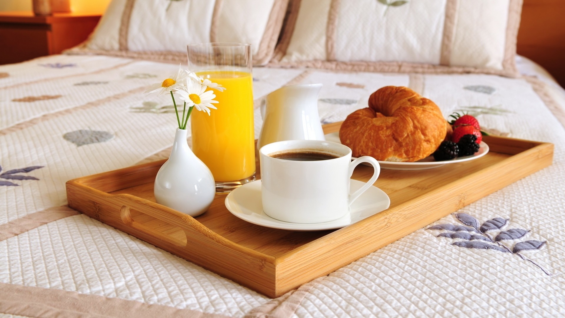 Breakfast tray with coffee, juice, croissant, and berries on a bed HD Wallpaper