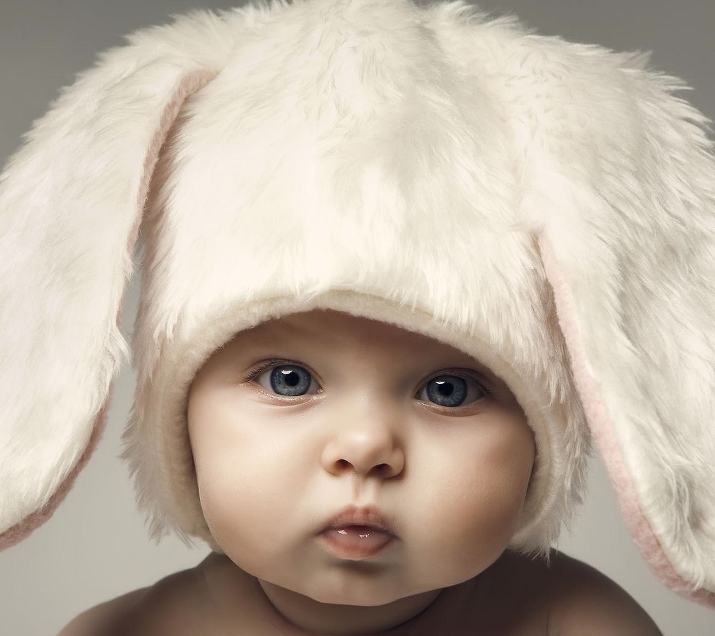 Baby wearing a white fluffy bunny hat HD Wallpaper