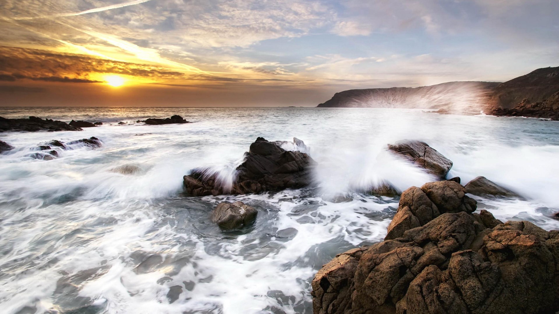Waves crashing on rocks at sunset HD Wallpaper