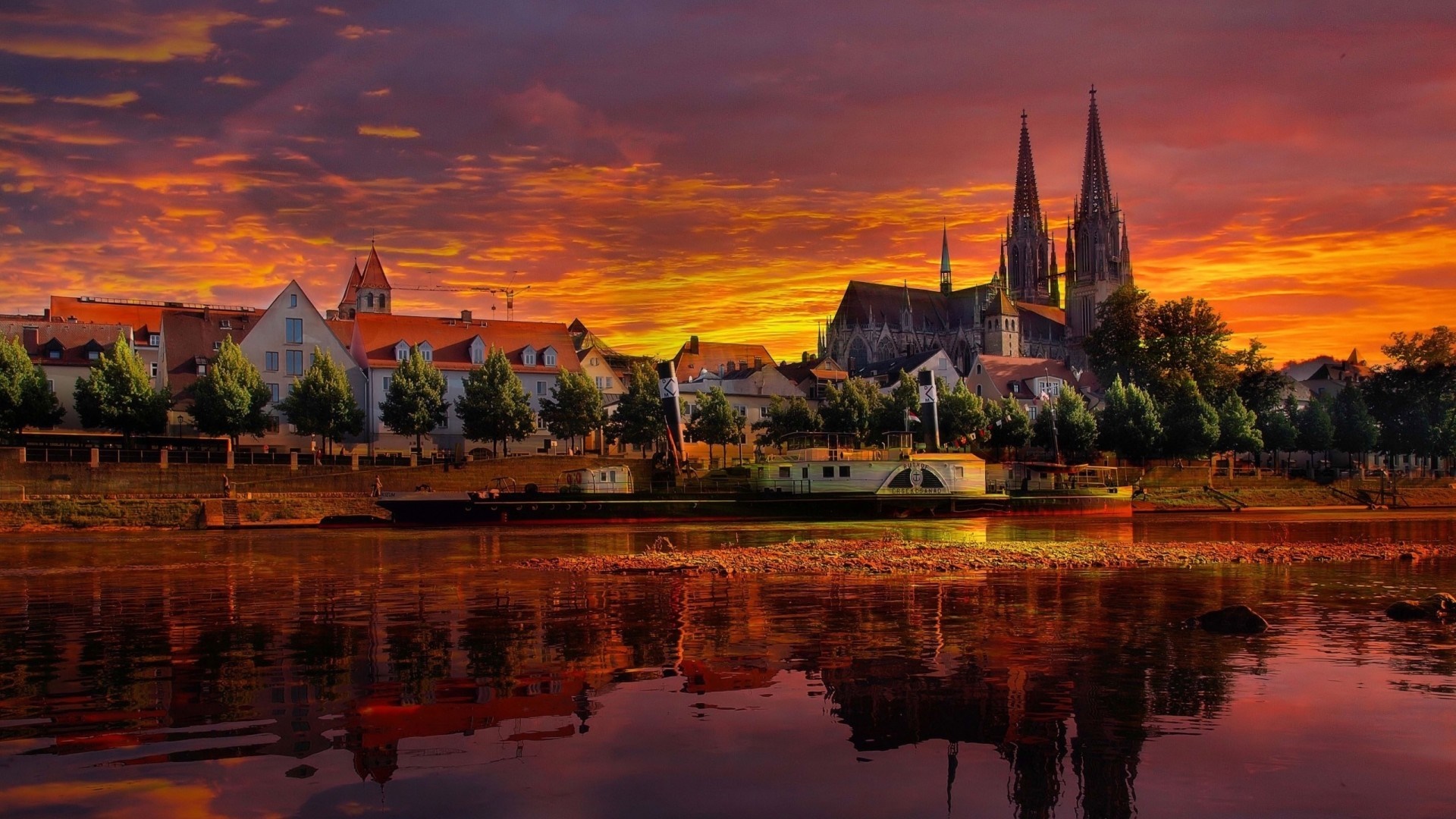 Regensburg cityscape with cathedral and river at sunset HD Wallpaper