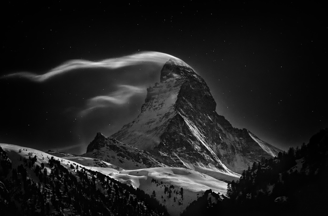 Matterhorn mountain at night with clouds and stars HD Wallpaper
