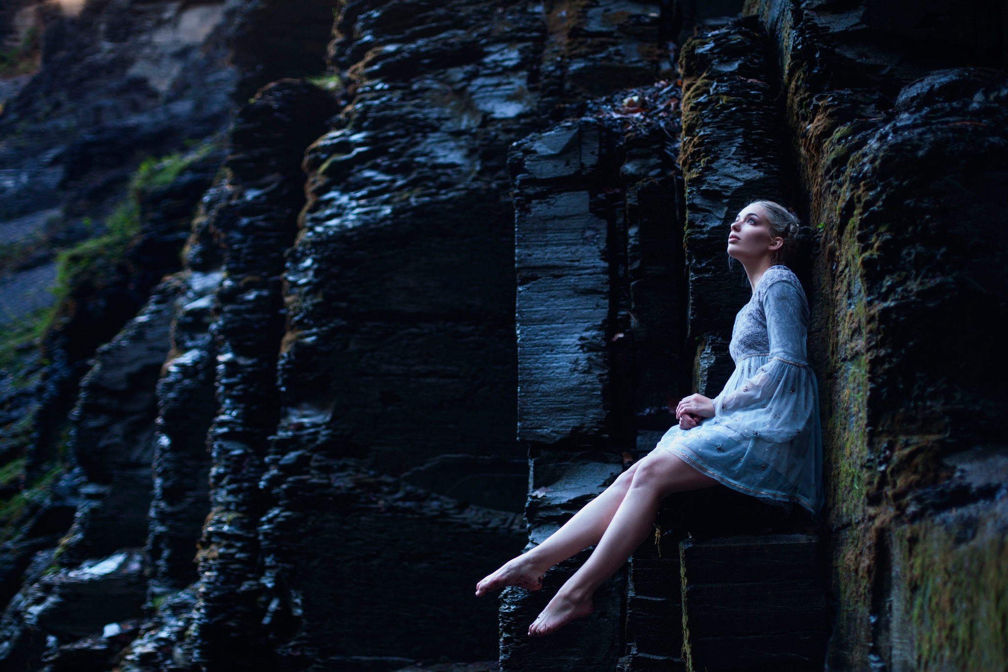 Woman in blue dress sitting on rocks HD Wallpaper