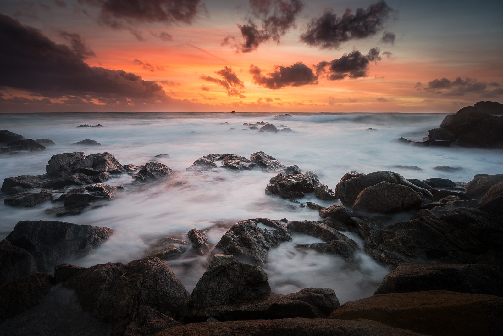 Sunset over rocky coast with waves HD Wallpaper