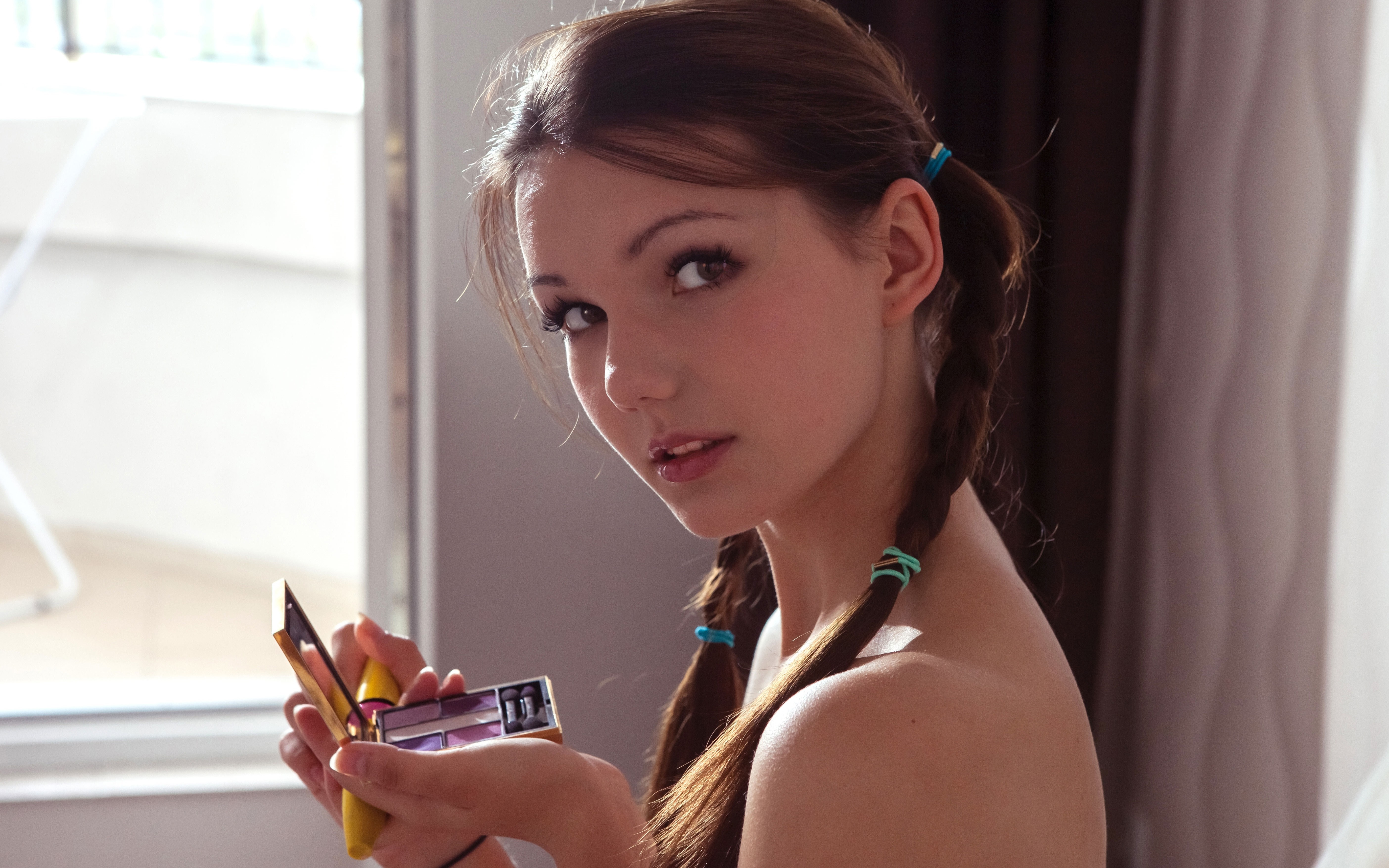 Young Woman Applying Makeup with Braided Hair HD Wallpaper