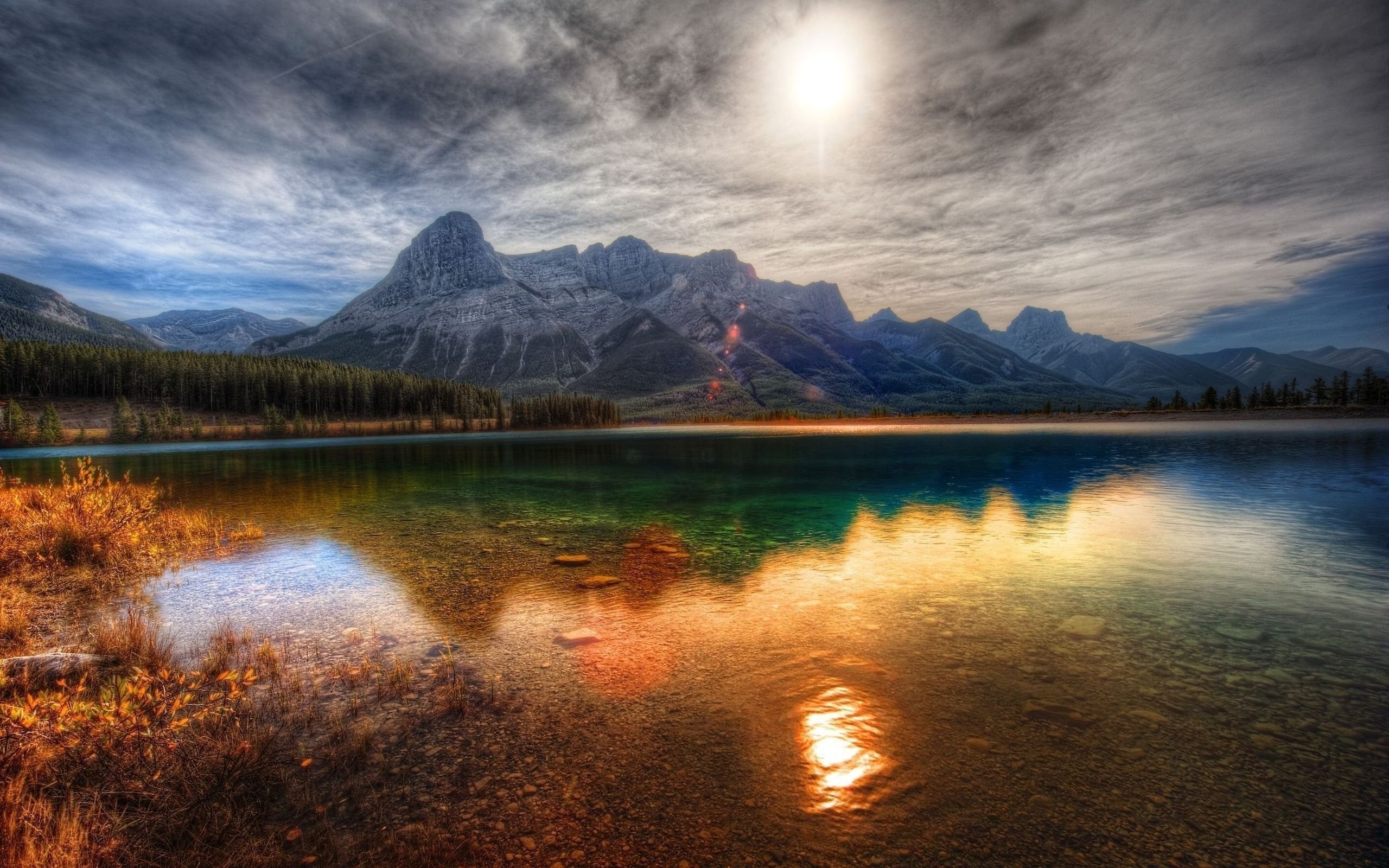 Mountains reflecting in a lake at sunrise HD Wallpaper