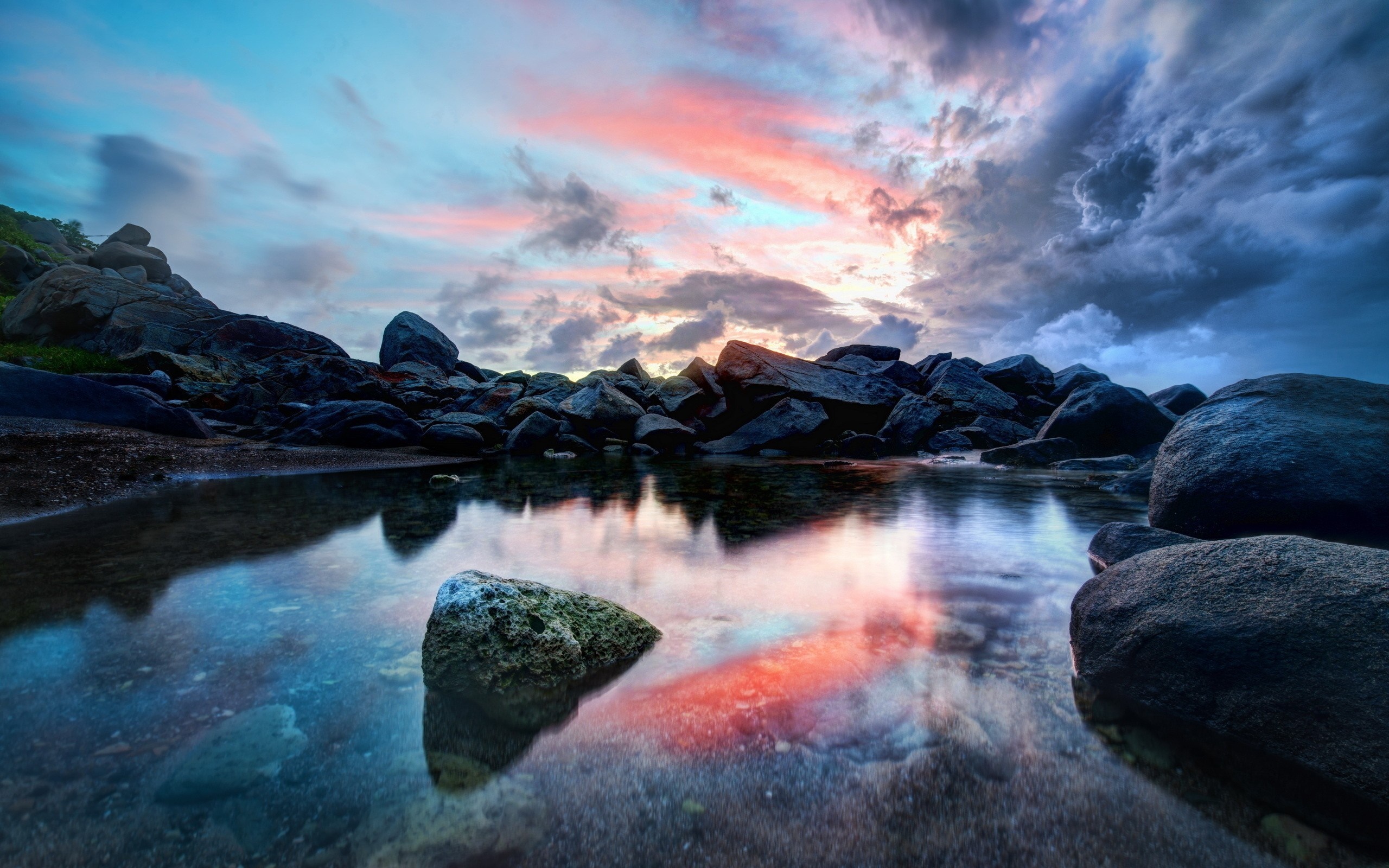 Rocky coast with colorful sunset reflected in water HD Wallpaper