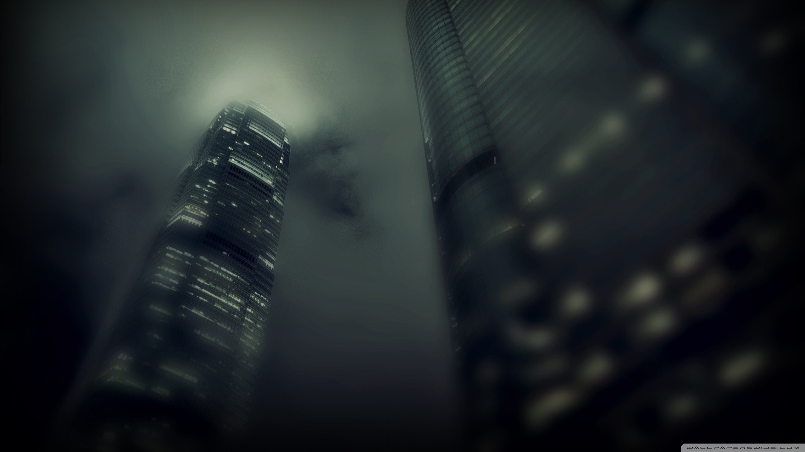 Skyscrapers shrouded in mist at night HD Wallpaper