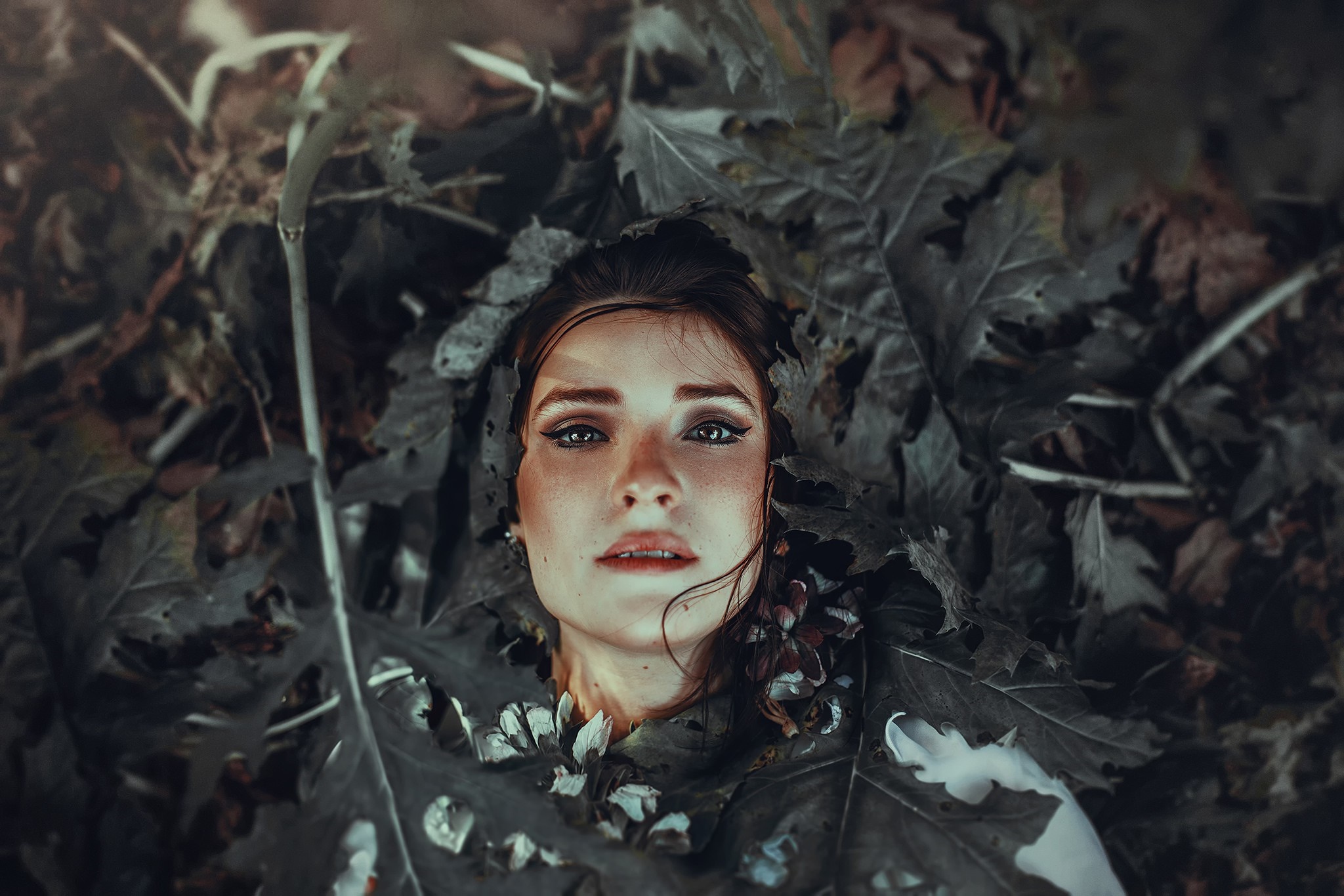 Woman lying in autumn leaves HD Wallpaper