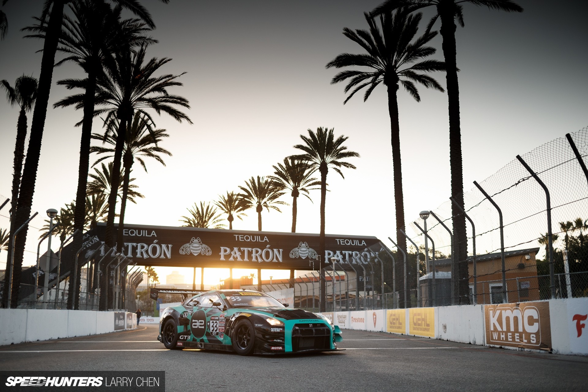 Nissan GT-R race car on track with palm trees and Patron banner HD Wallpaper