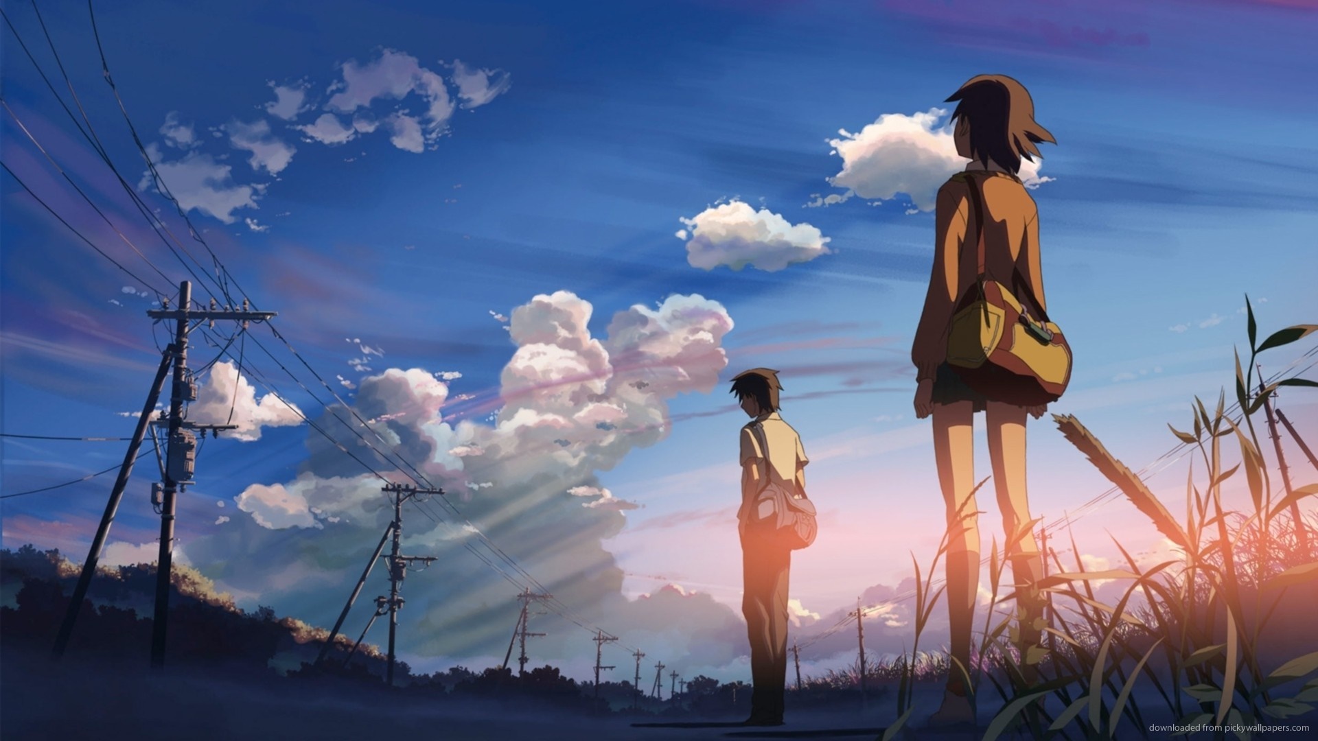 Two people stand under a cloudy sky at sunset HD Wallpaper