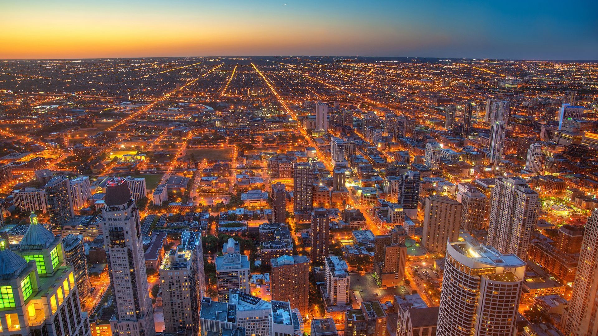Aerial view of Chicago cityscape at dusk with glowing lights HD Wallpaper