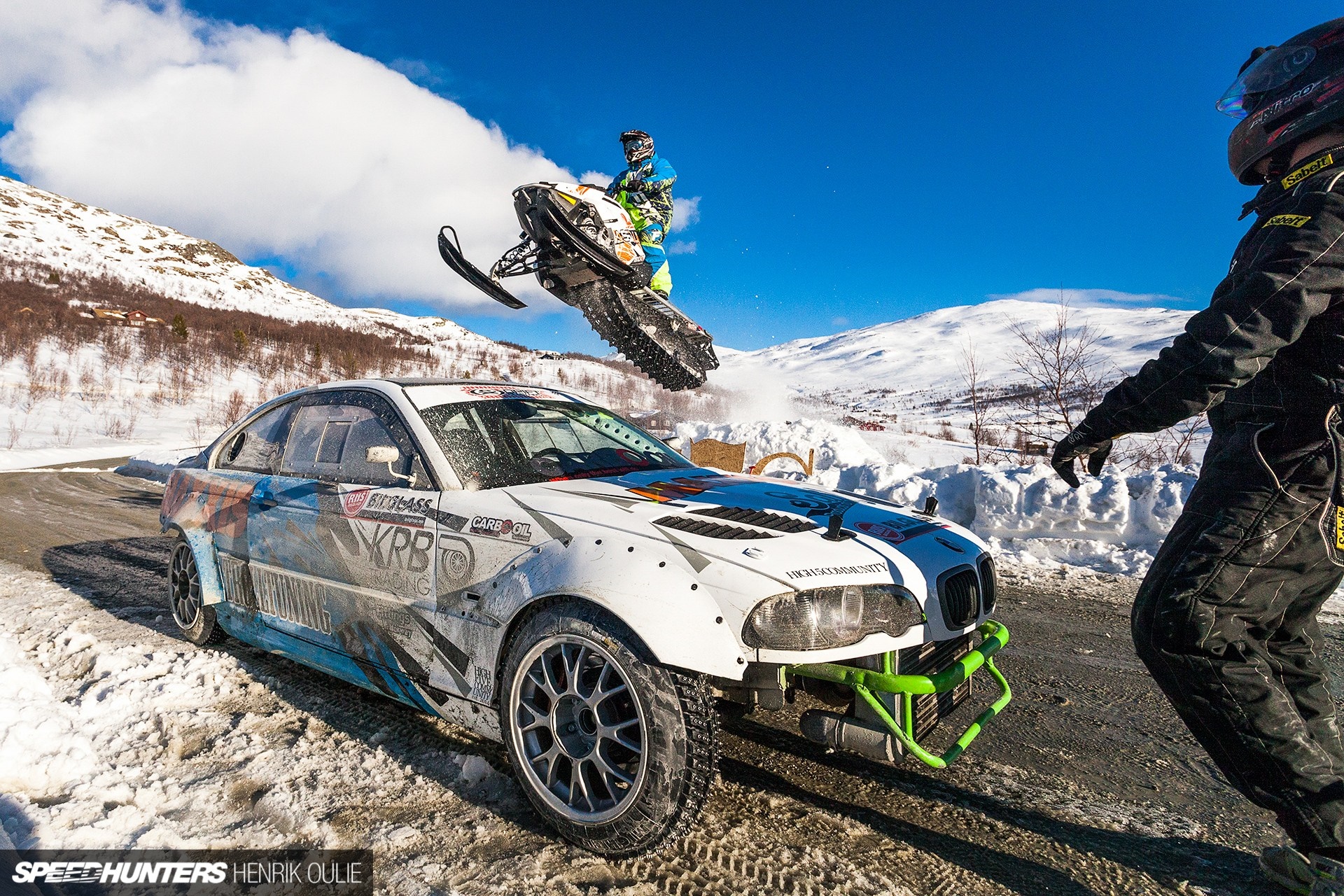 Snowmobile jumps over BMW M3 during winter drift event HD Wallpaper
