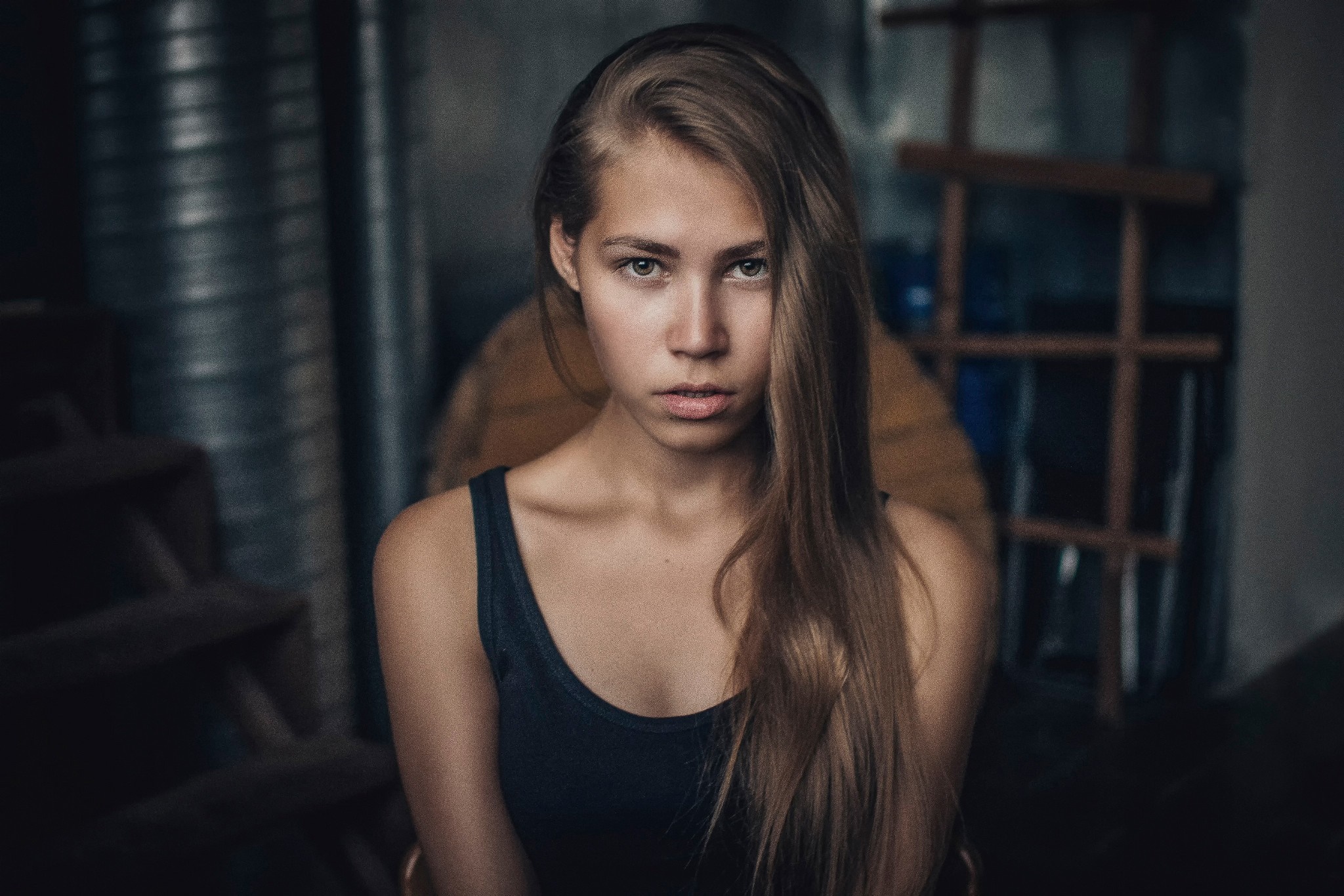 Woman with long brown hair in a dark setting HD Wallpaper