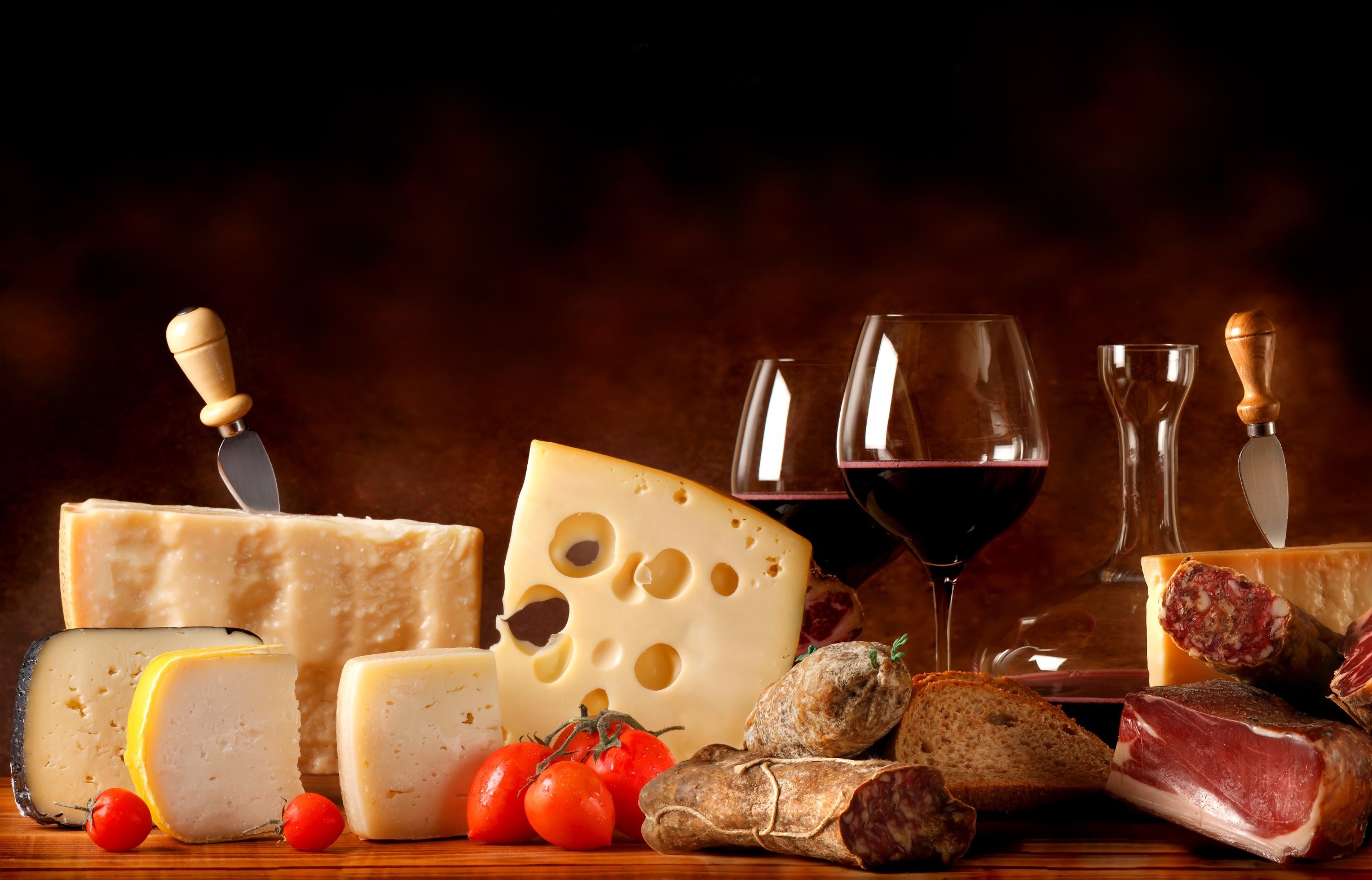 Still life of cheese, cured meats, bread, tomatoes, and red wine HD Wallpaper