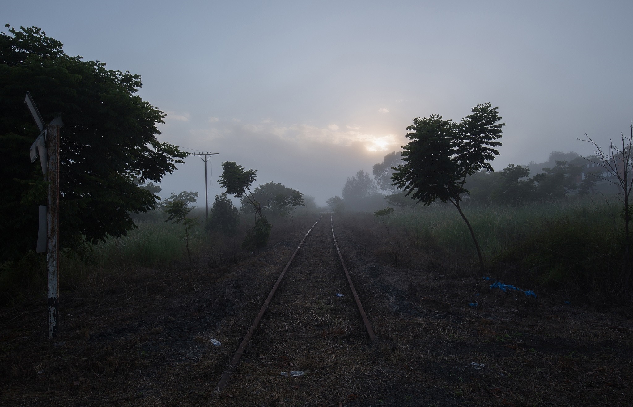 Railway tracks disappearing into fog at sunrise HD Wallpaper