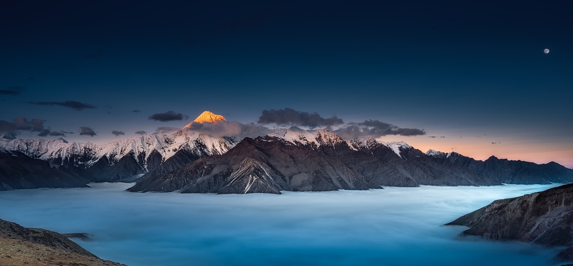 Mountain range above clouds at dawn with moon HD Wallpaper