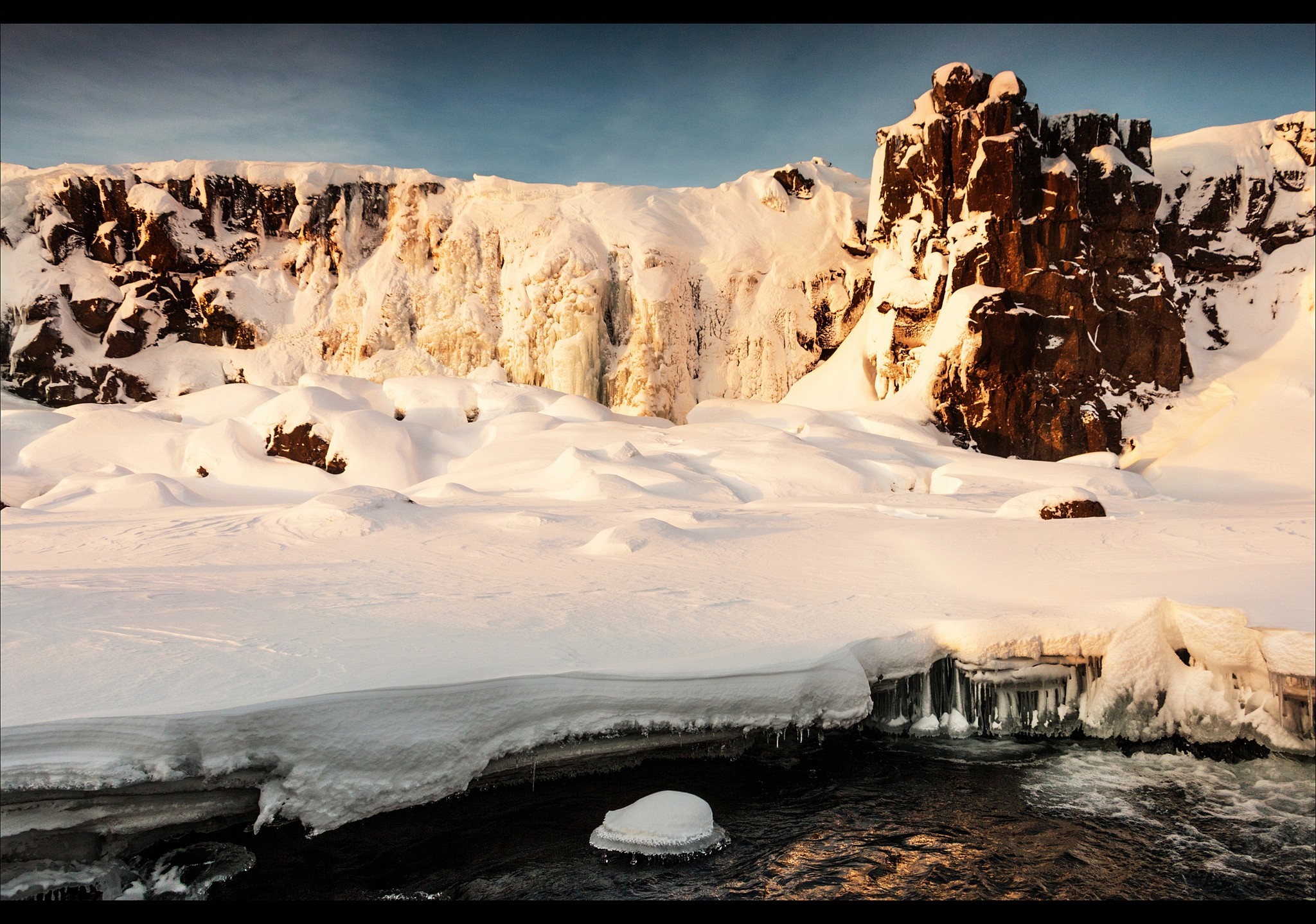 Frozen waterfall and rocky cliffs in winter landscape HD Wallpaper