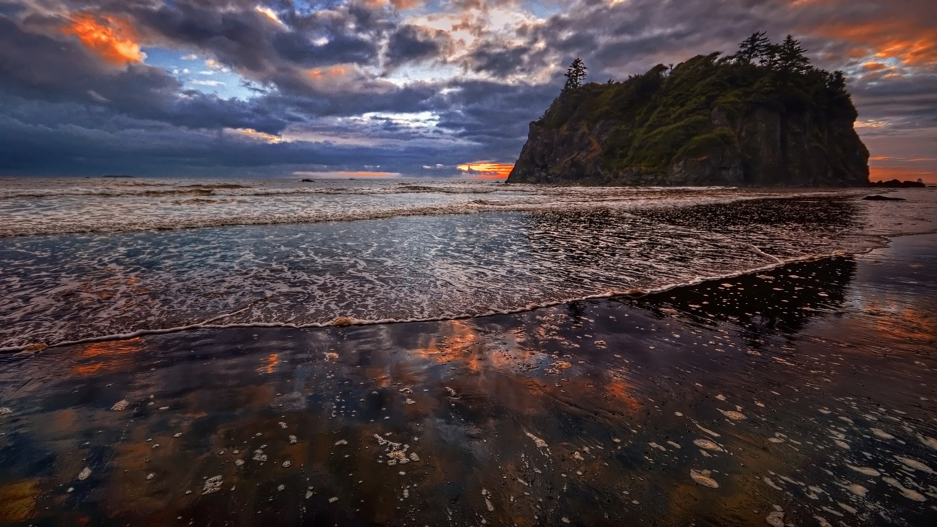 Dramatic sunset over a rocky island and beach HD Wallpaper