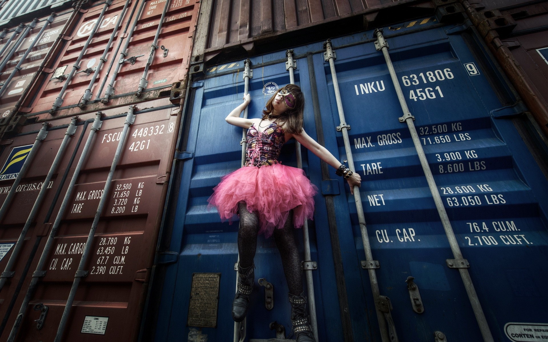 Woman in pink tutu and mask on shipping containers HD Wallpaper