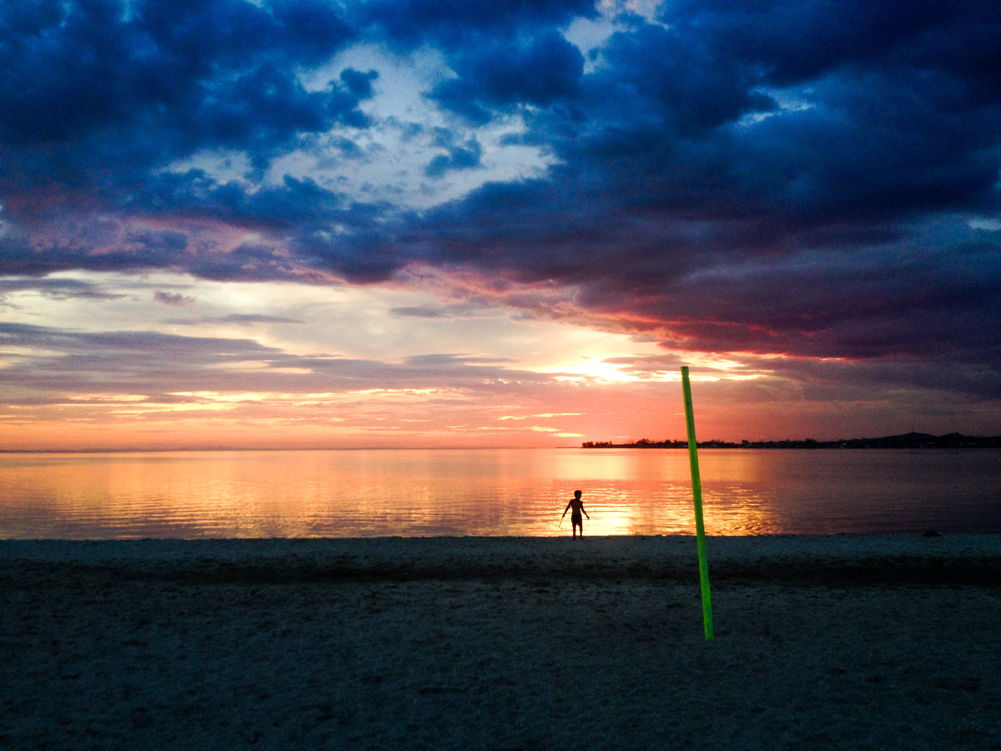 Silhouette of a child on a beach at sunset HD Wallpaper