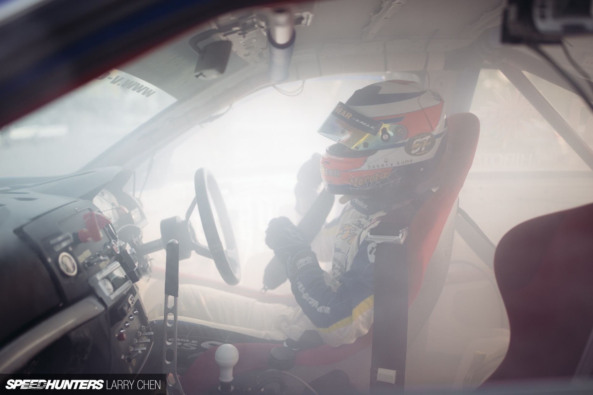 Drifting race car interior with driver in helmet HD Wallpaper