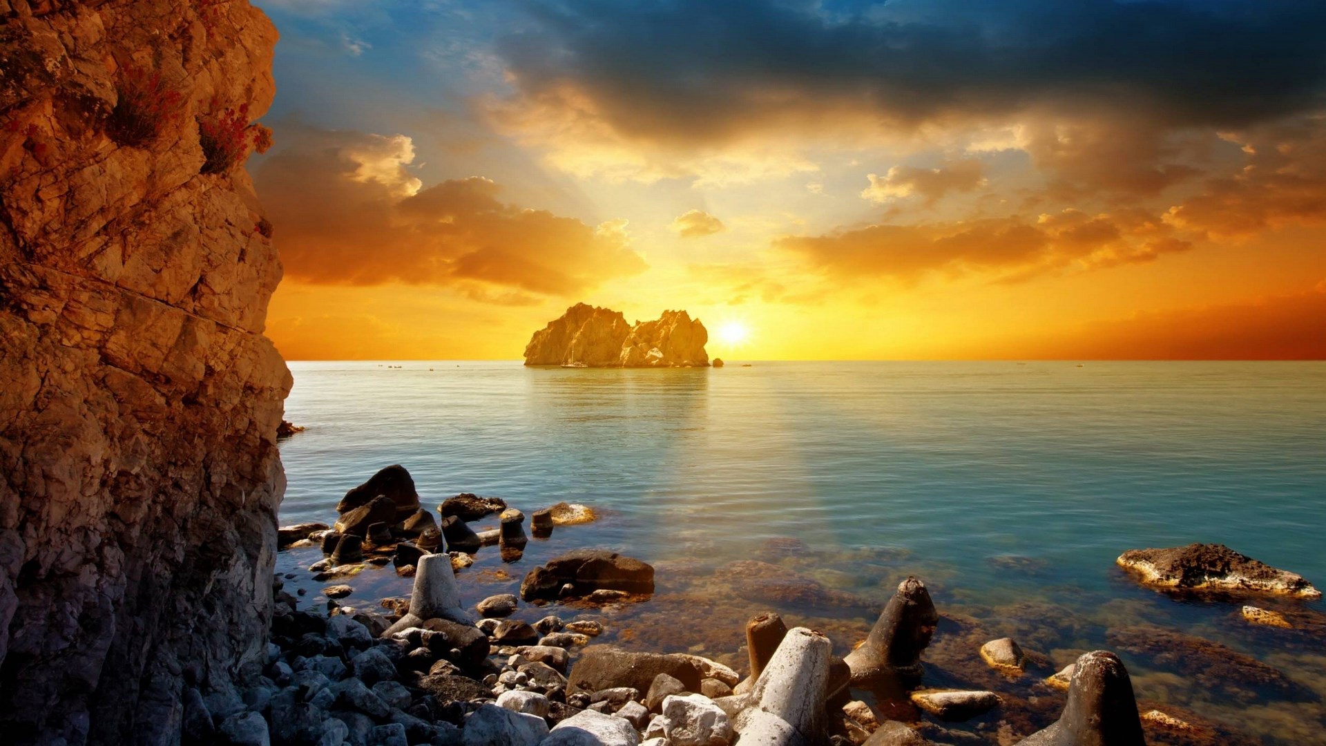 Rocky coastline with island and sunset over the sea HD Wallpaper